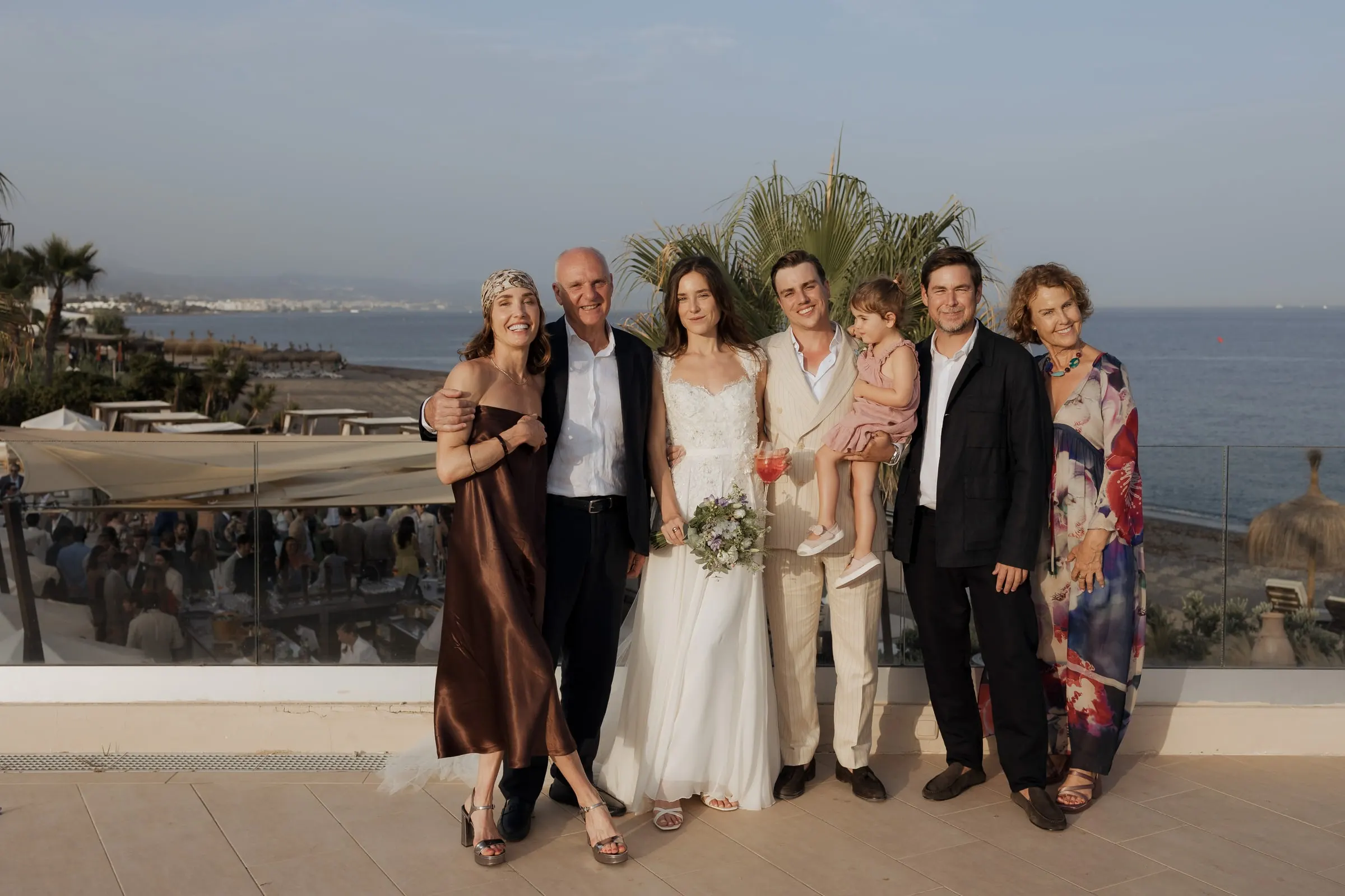 Bride and groom with family on the terrace above the sea at Barbillón, Marbella