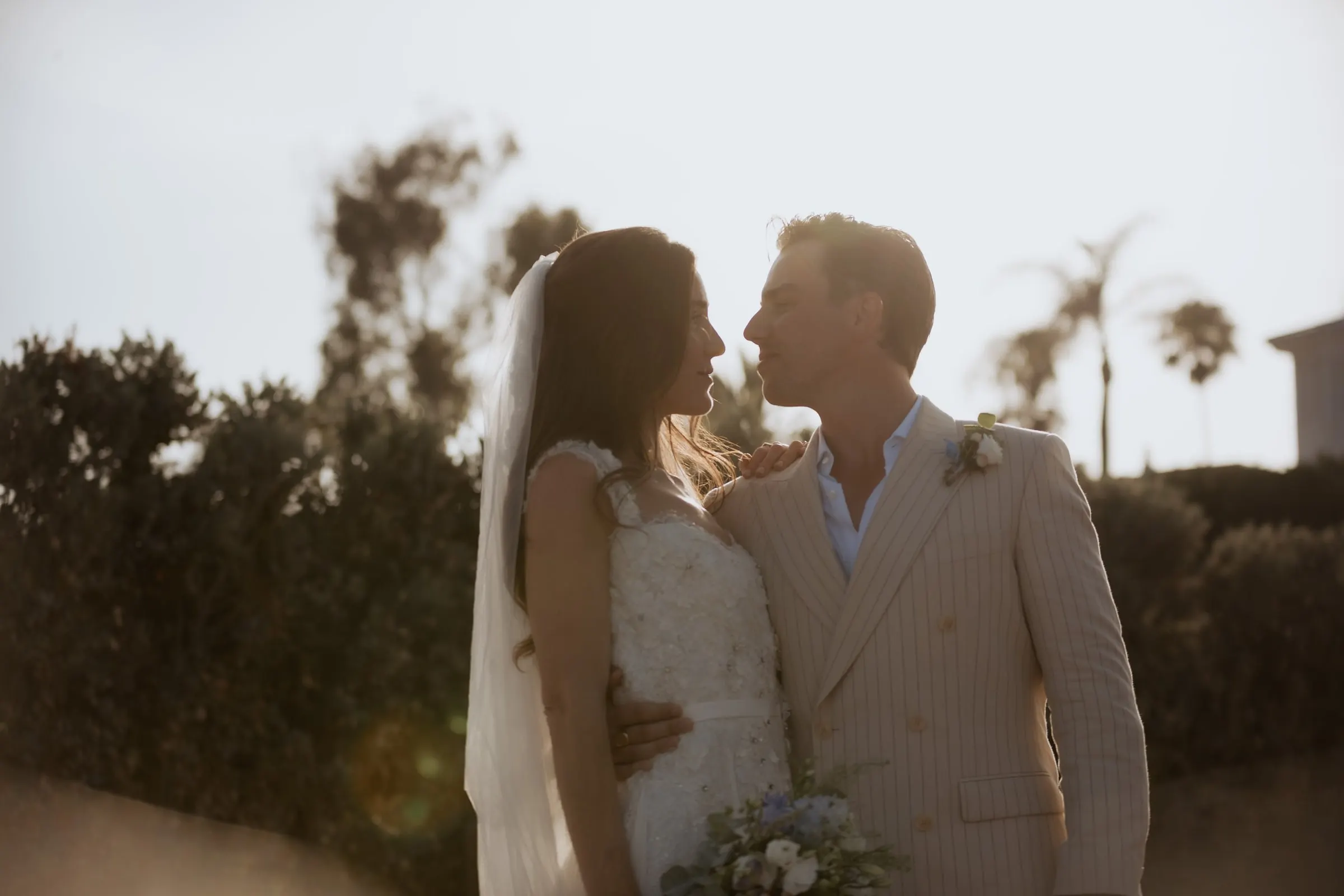 Bride and groom face to face, backlit by the evening sun among the trees, Barbillón, Marbella
