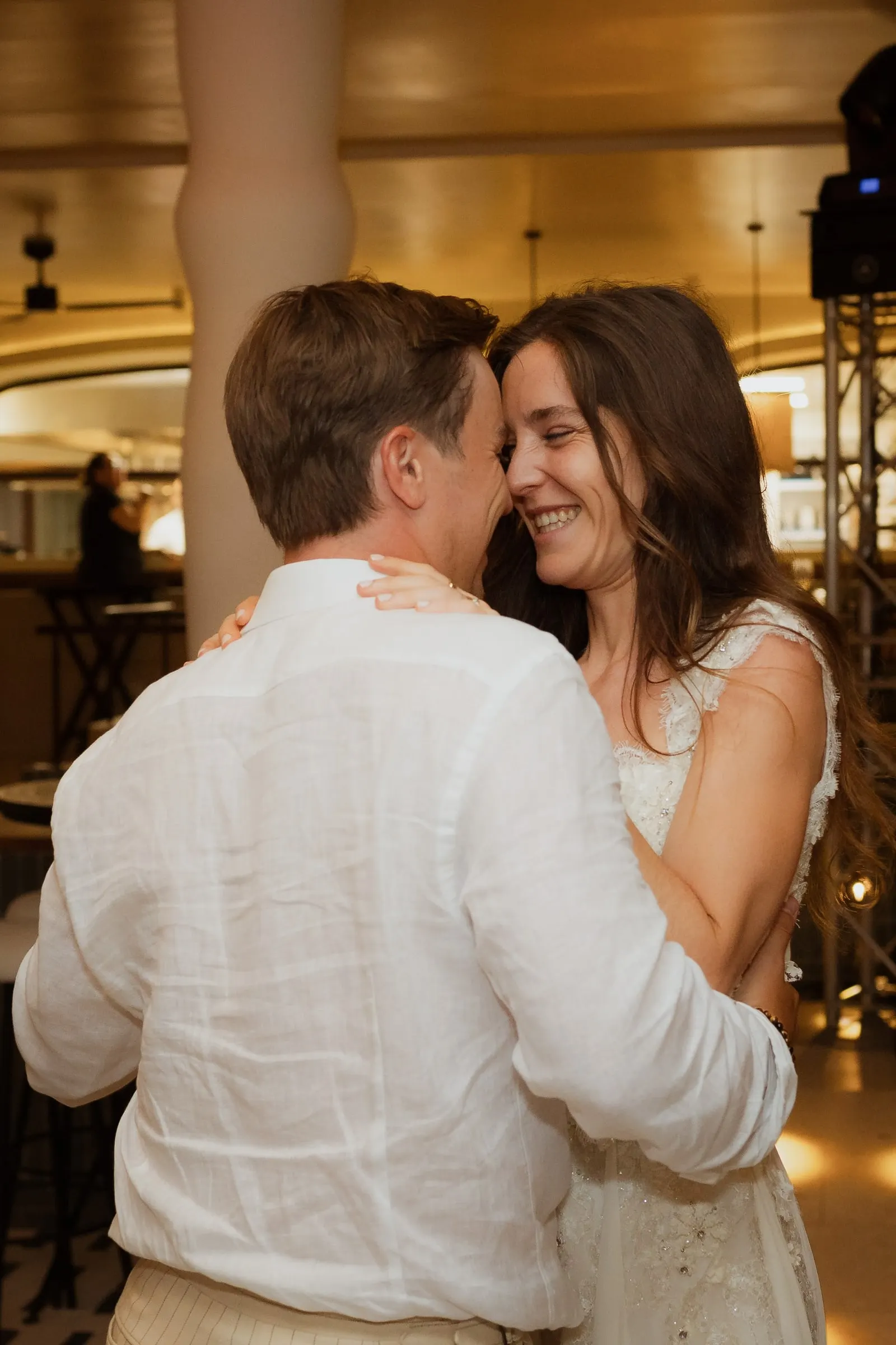 Bride and groom slow dancing in the warmly lit restaurant, Barbillón, Marbella