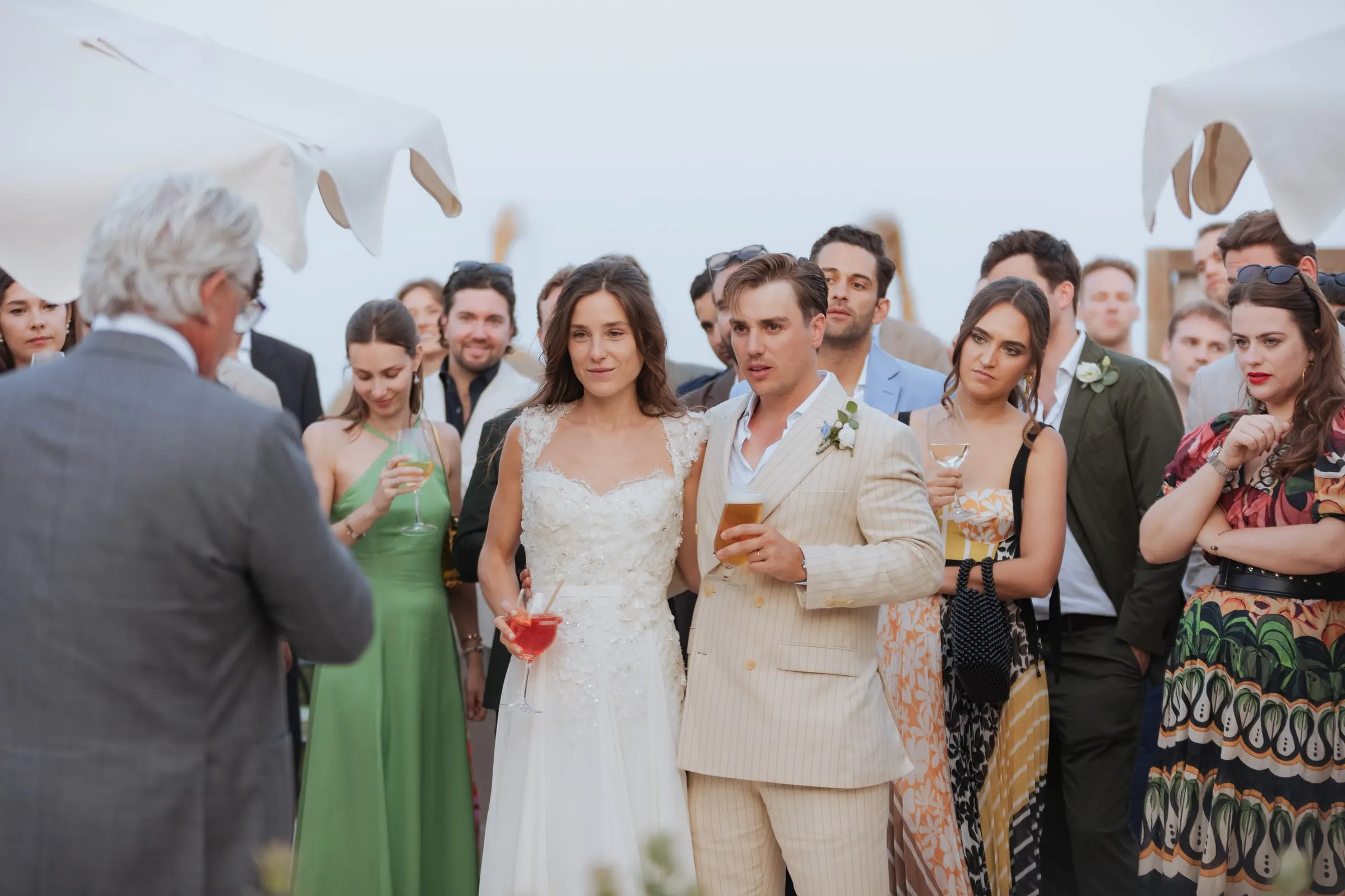 Bride and groom listening to a speech among guests at the cocktail hour, Barbillón, Marbella