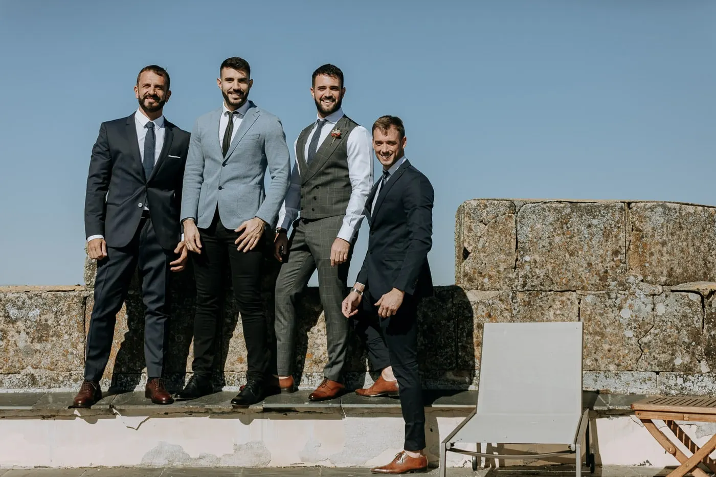 Groom with three friends in suits on the castle wall, Castillo del Buen Amor