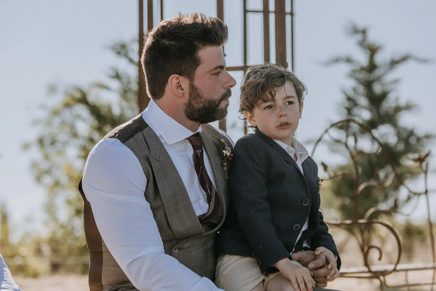 Groom with a little boy on his knee during the ceremony, Salamanca