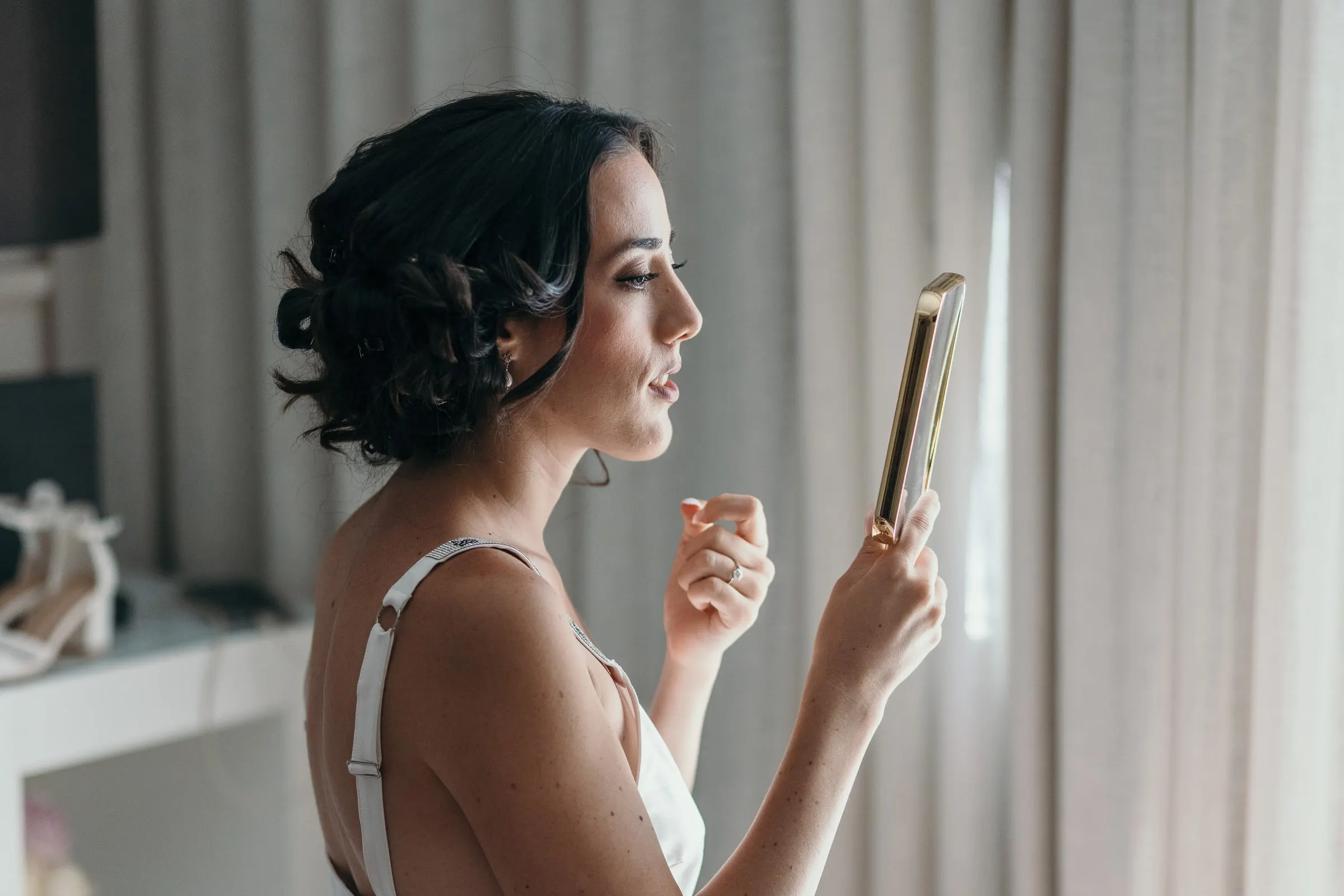 Sara reads a framed note by the window while she gets ready