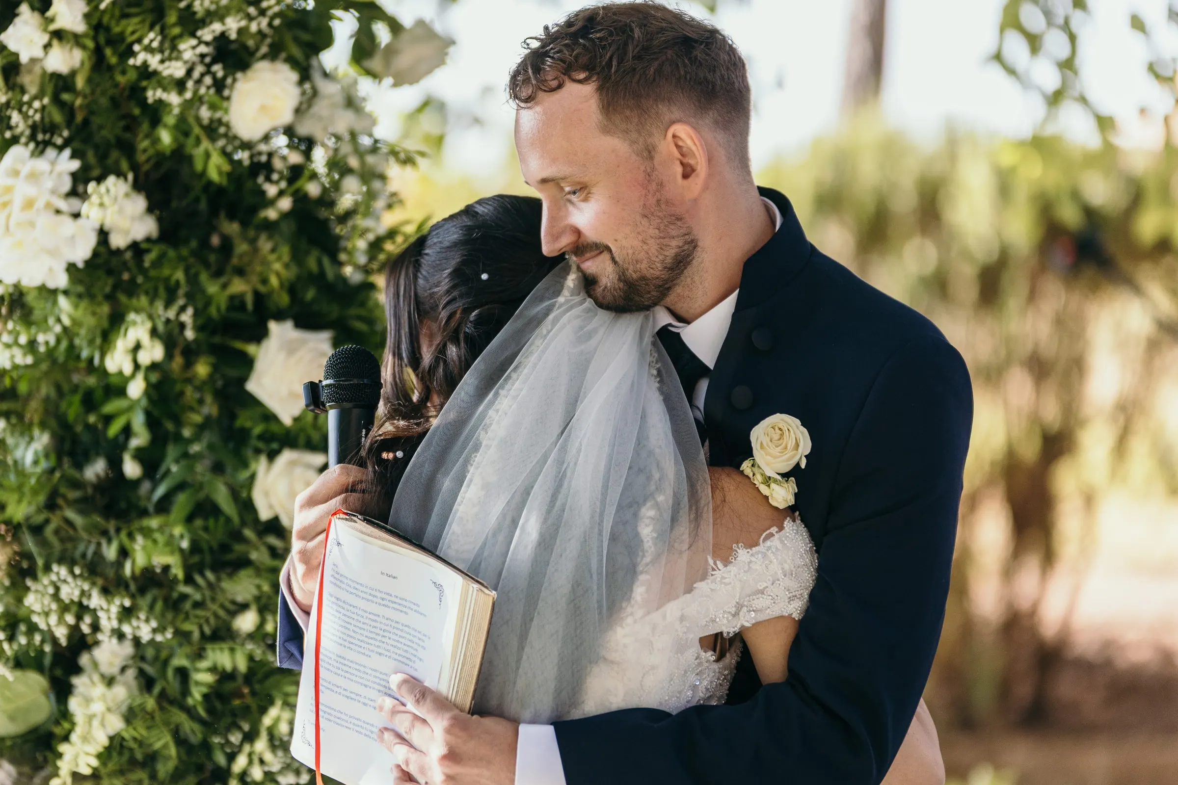 Vincent hugs Sara after the vows, her veil catching the light