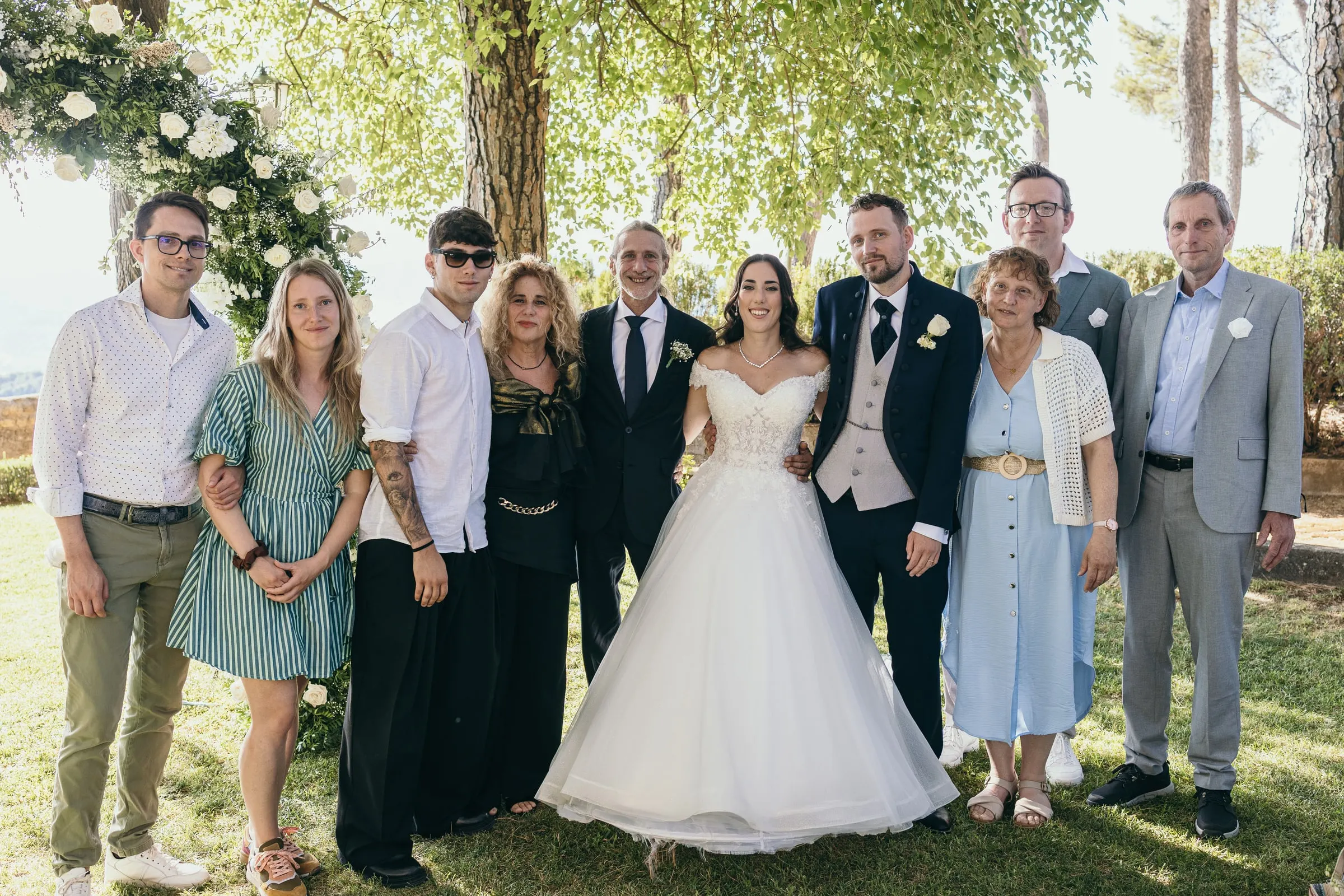 Group photo of the couple with family on the lawn of the Reina Victoria