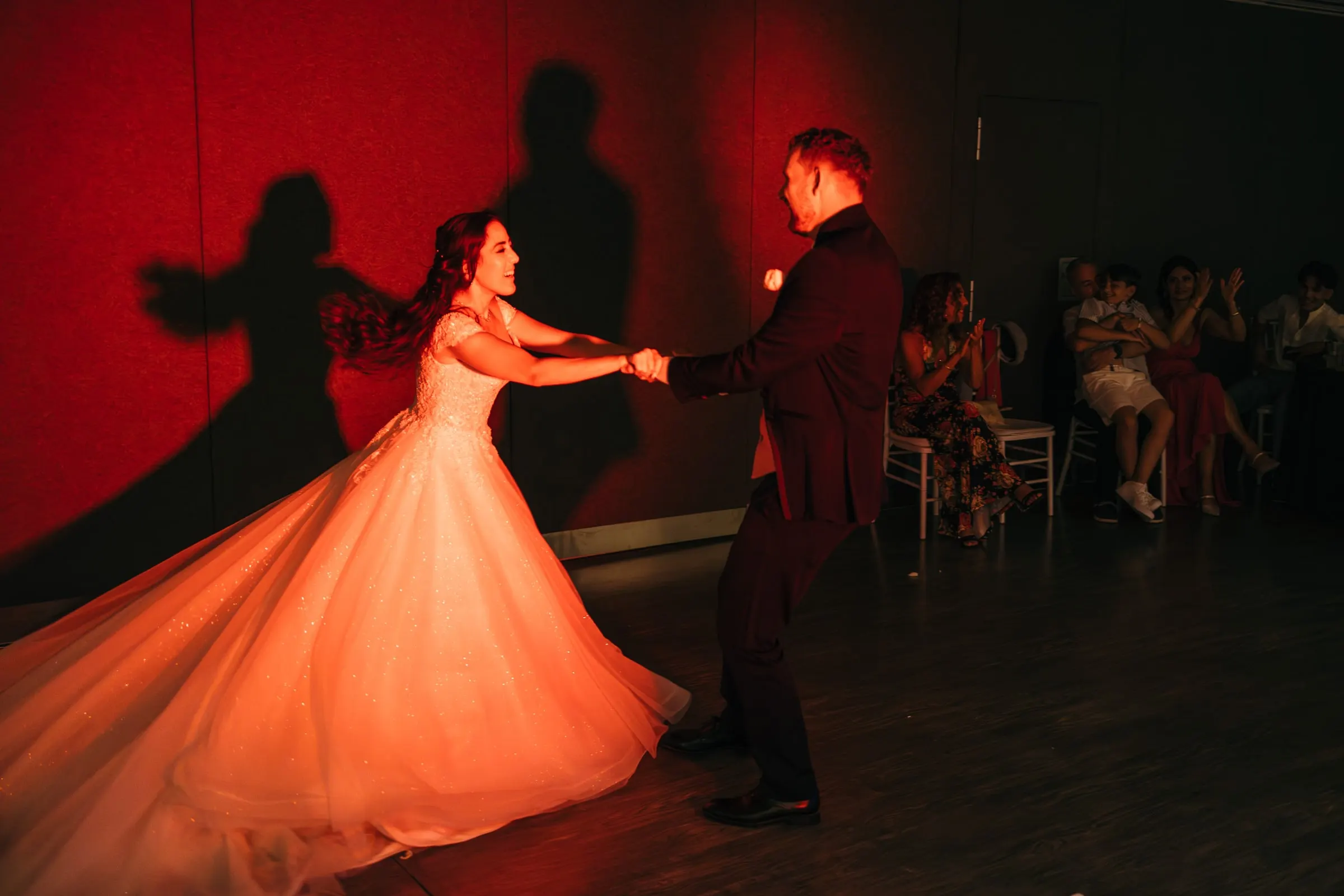 First dance in a room lit red, Sara's skirt spinning