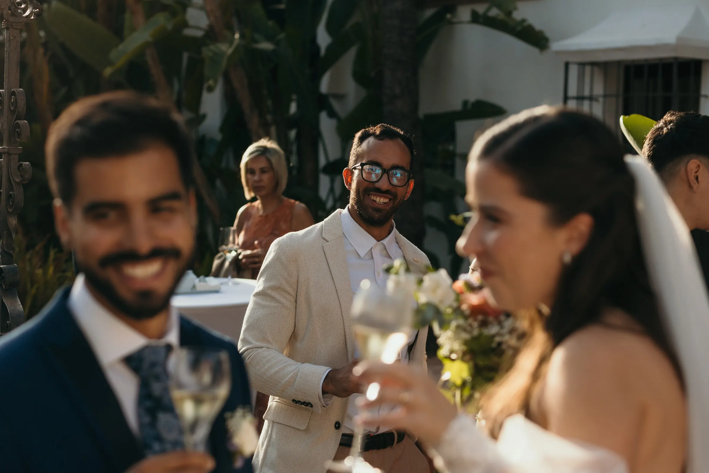 Groom and guests raising their glasses with the bride in her veil in front, Cortijo San Francisco, Estepona