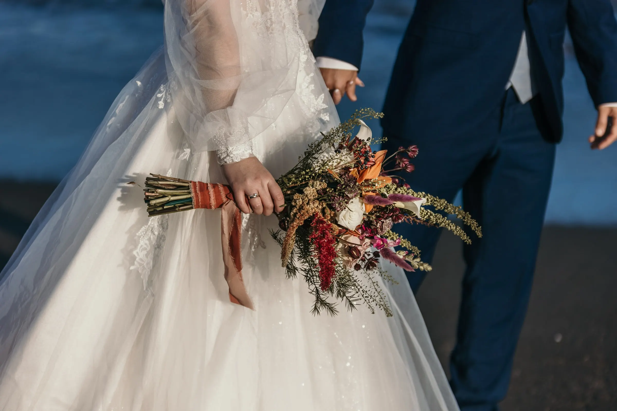 Bride's dried-flower bouquet with ribbons as she walks beside the groom by the sea, Cortijo San Francisco, Estepona