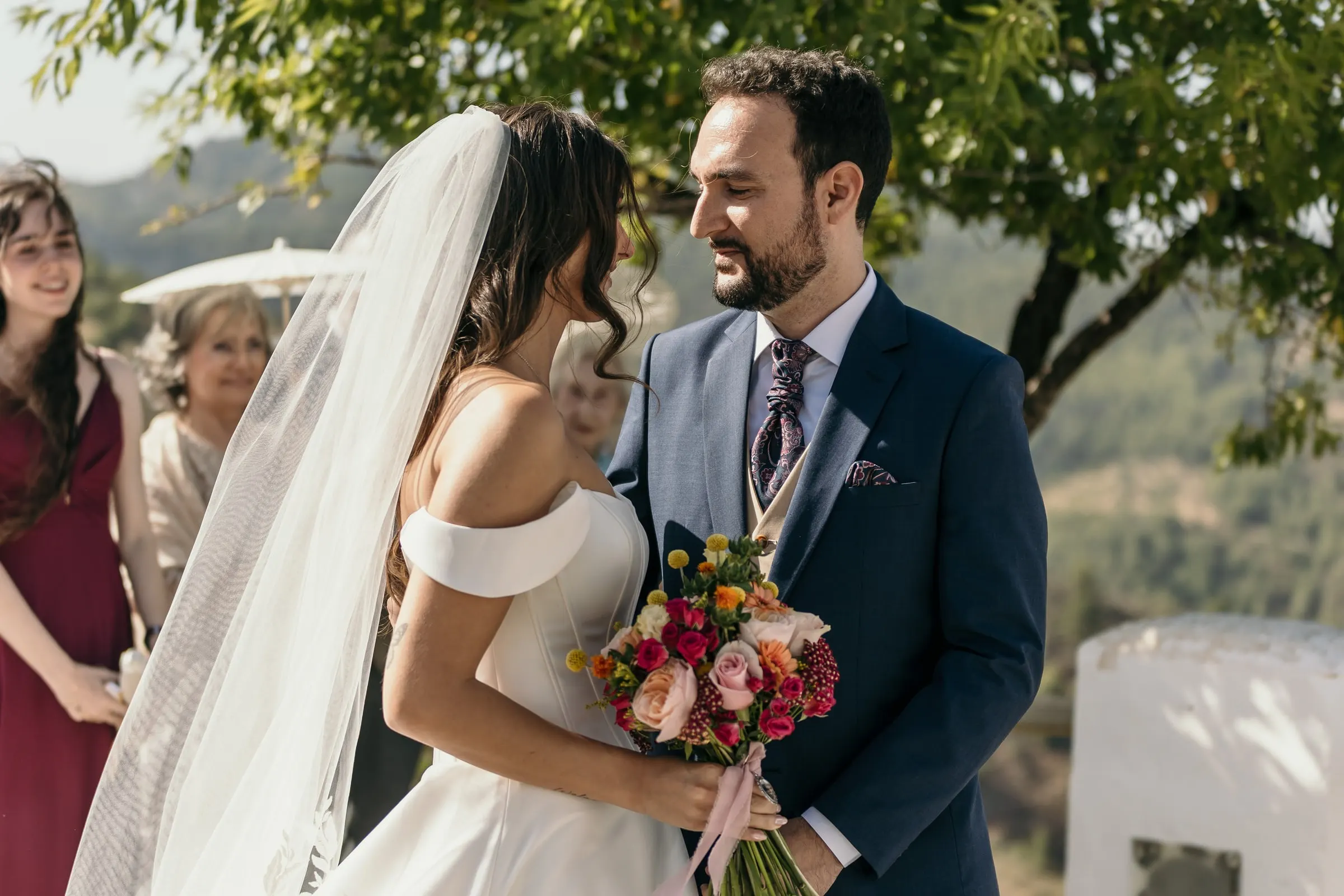 Bride and groom meeting at the altar with green hills behind, outdoor wedding on the Costa del Sol