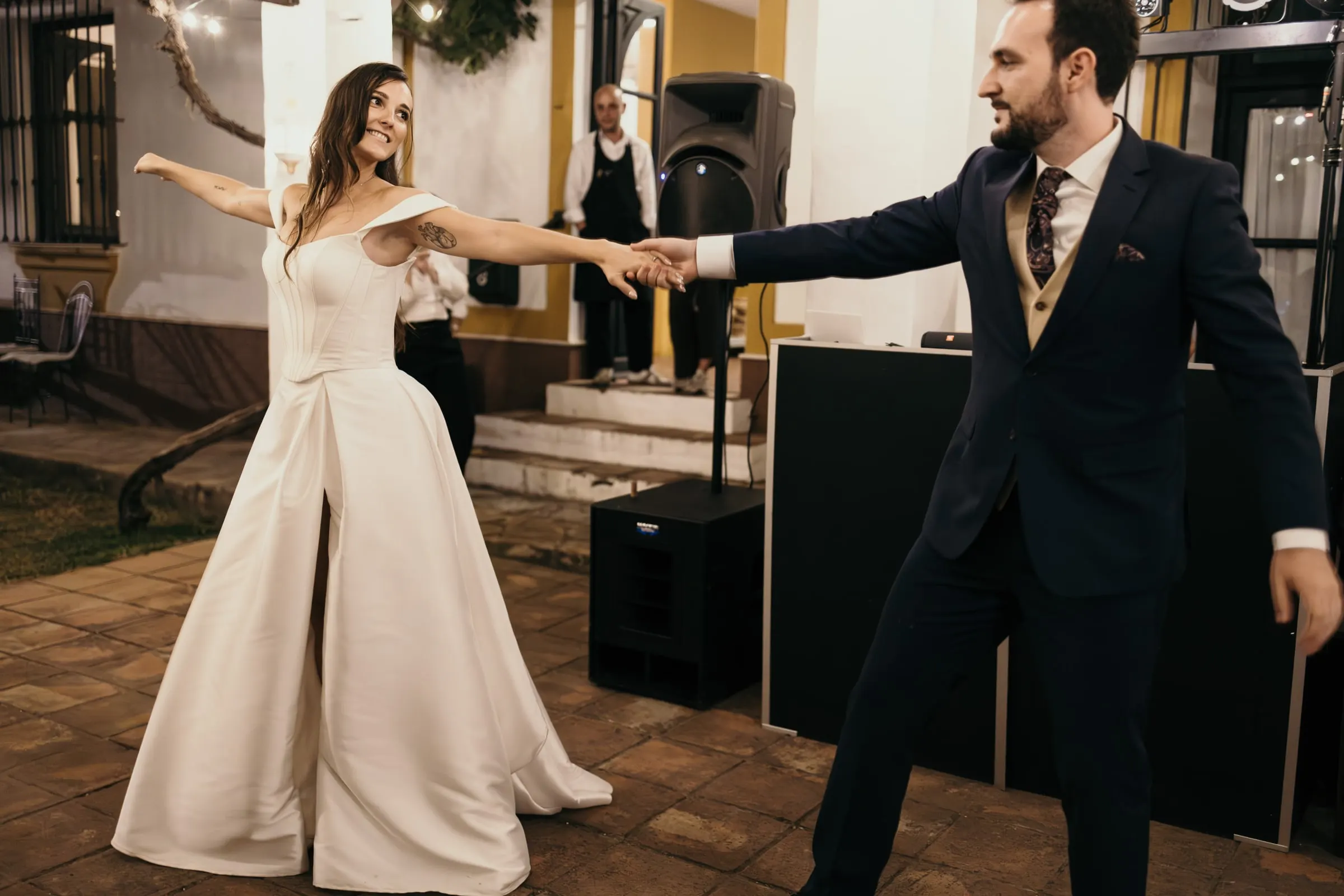Bride spinning out with her arm outstretched during the first dance