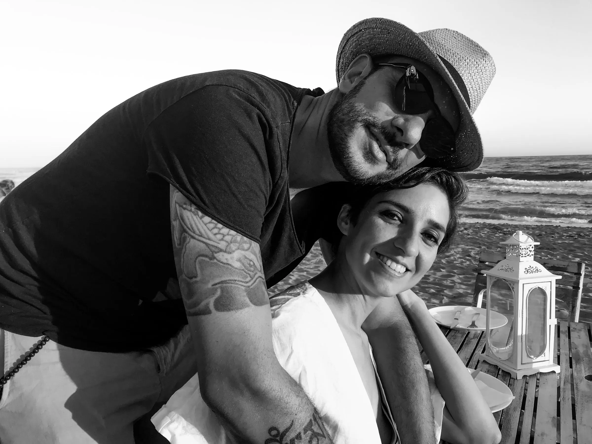 Diego and Tamara, the husband-and-wife team behind Picart, laughing together on the beach