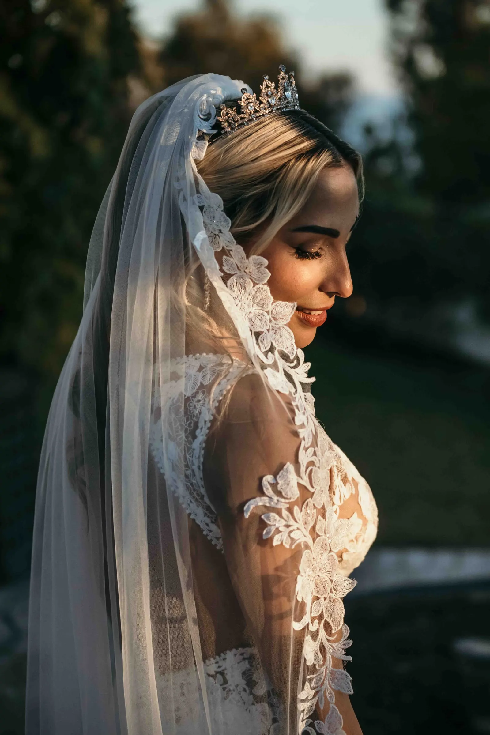 Bride with a lace veil and tiara at sunset, wedding in Marbella