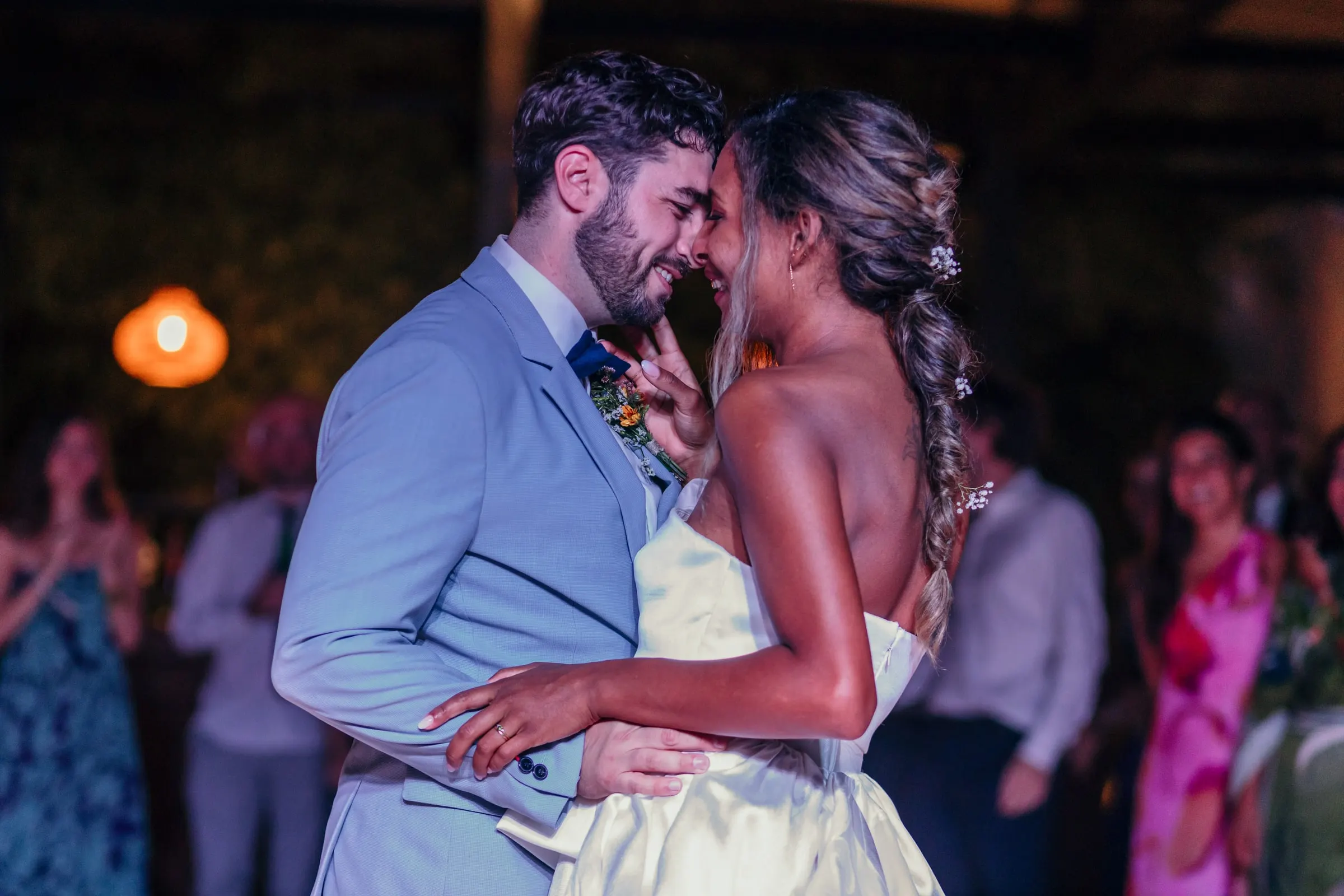 First dance, foreheads together, as guests watch with their phones