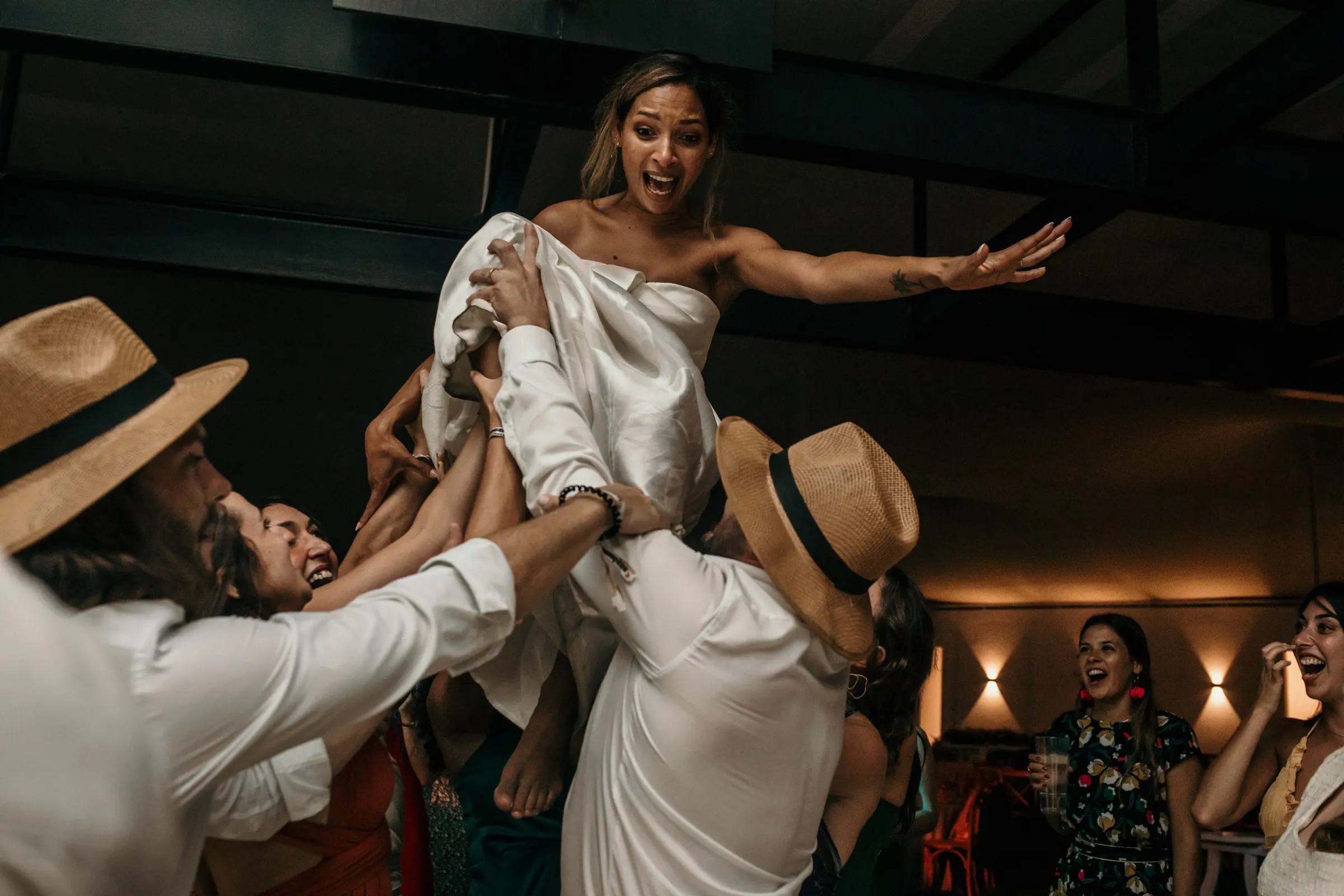 Guests lifting the bride high above the dance floor