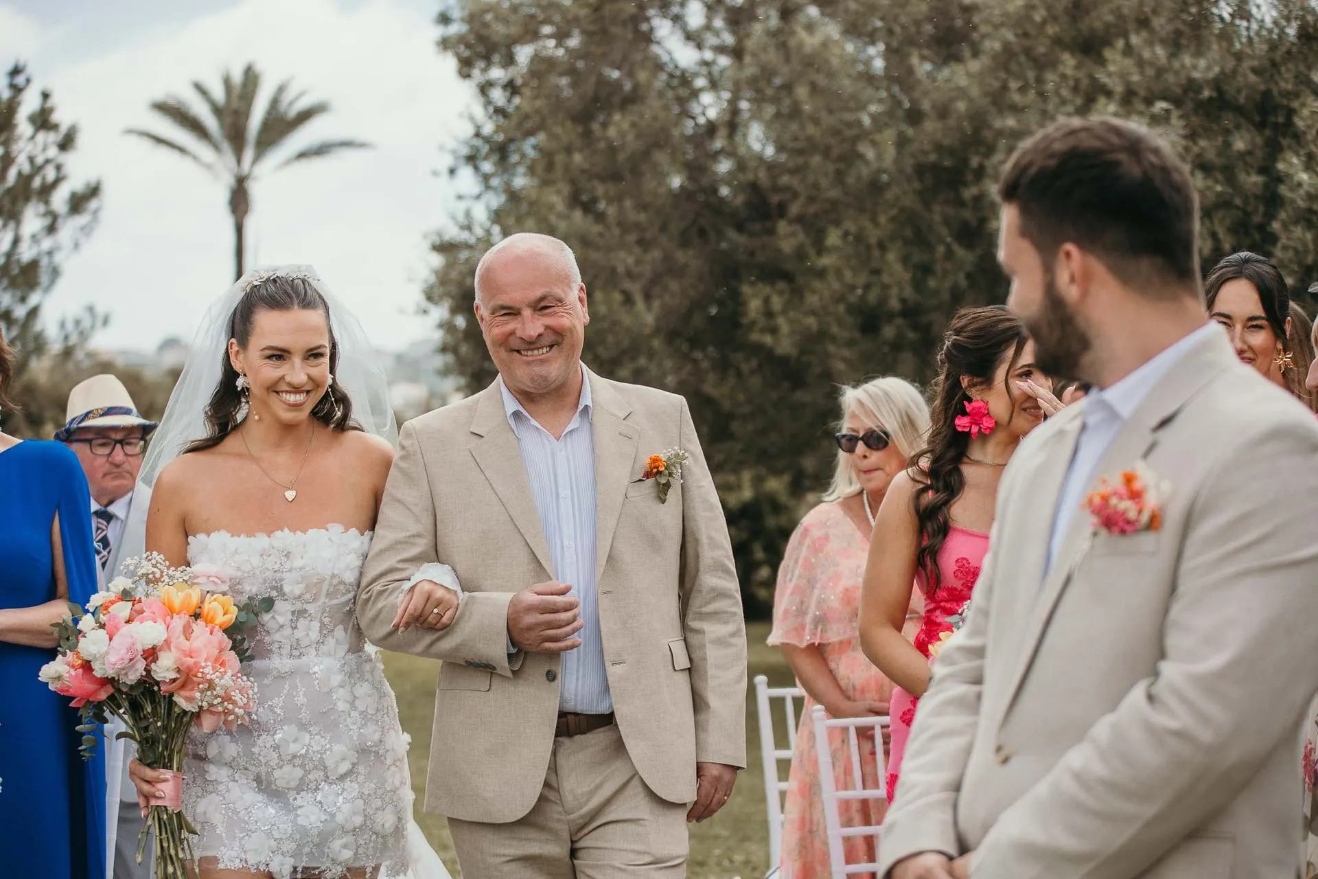 Bride walks down the aisle on the arm of an older man, smiling, groom waiting, Hacienda San José, Mijas