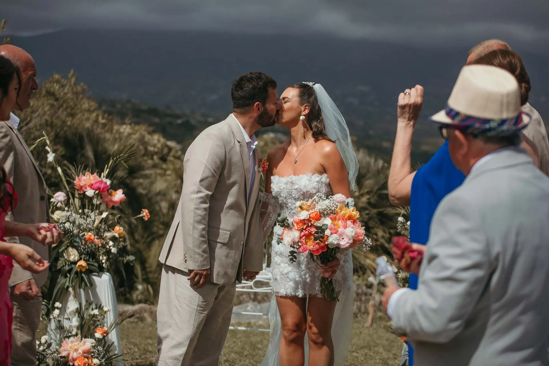 The couple share a kiss at the end of the ceremony as guests clap around them, Hacienda San José, Mijas