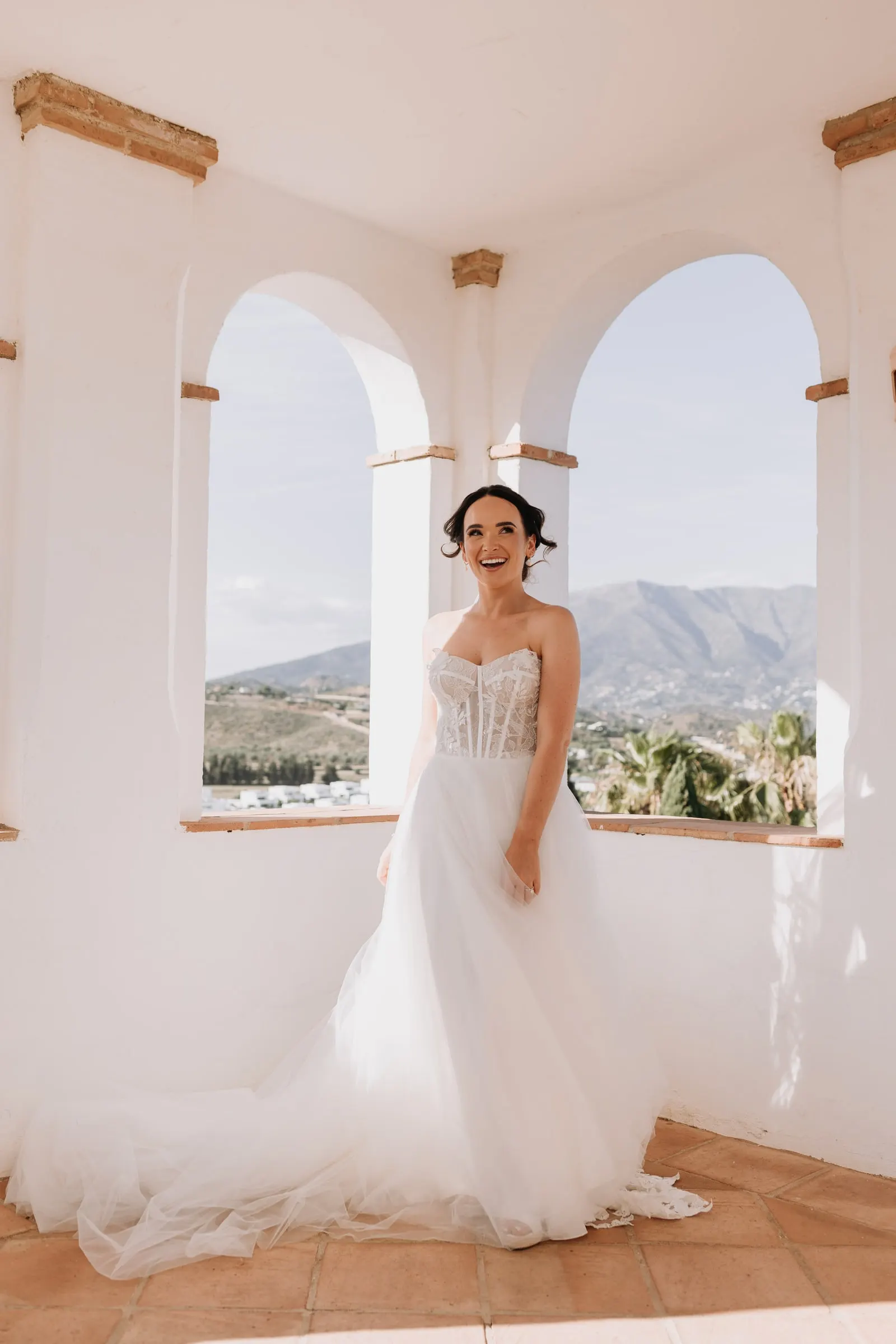 Bride laughing in the arched tower at Hacienda San José, Mijas