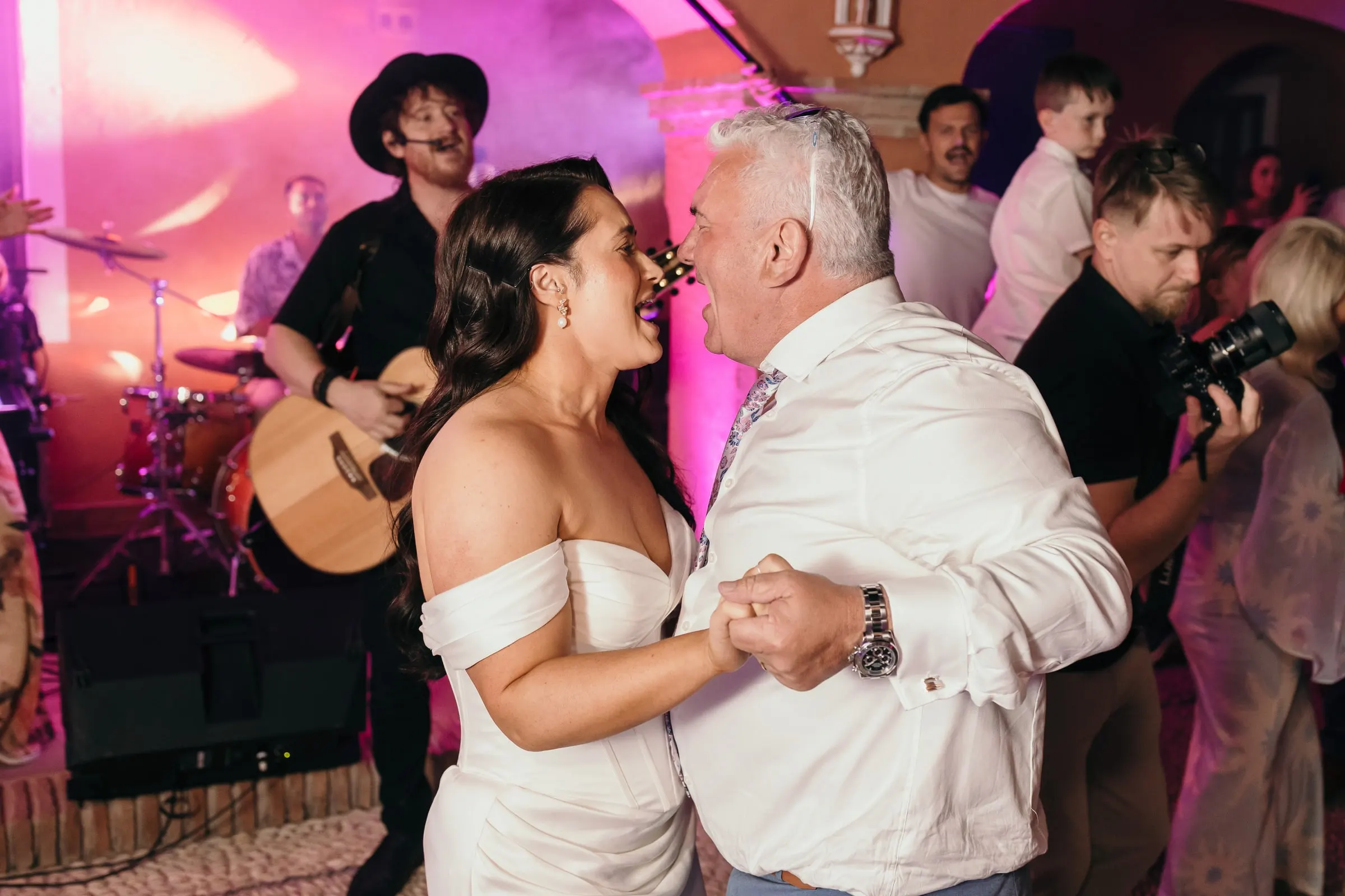 Bride dancing in front of the band's drum kit and guitarist, Hacienda San José