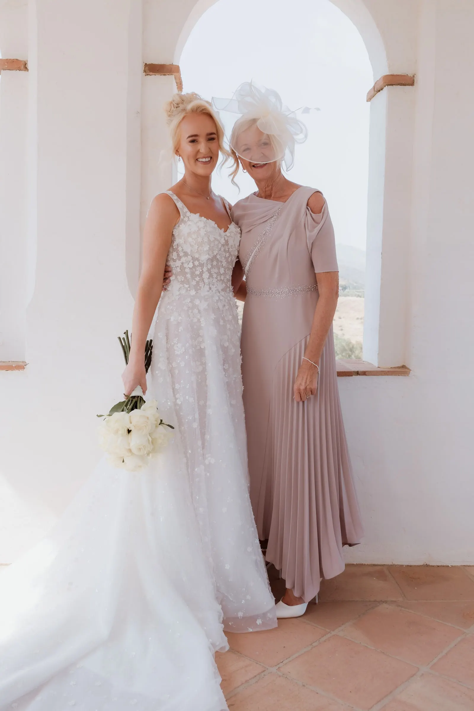 Bride and her mother arm in arm in the tower at Hacienda San José