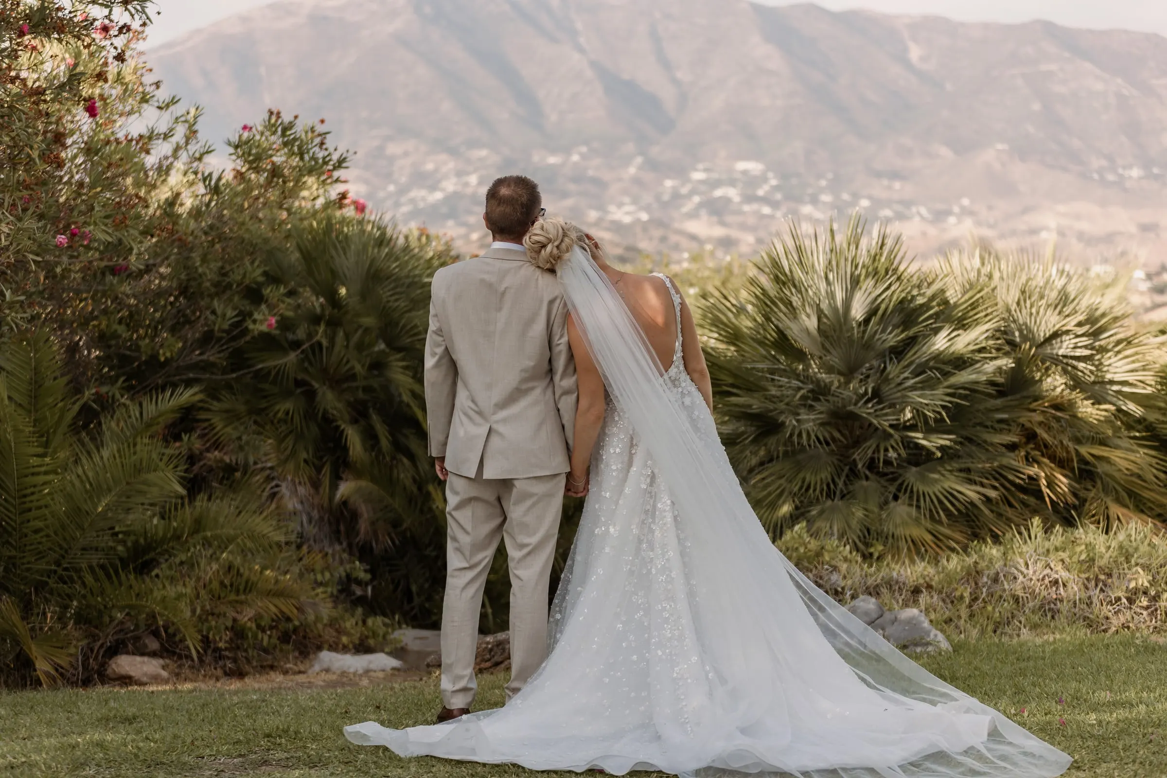 Couple seen from behind looking at the mountains above Mijas