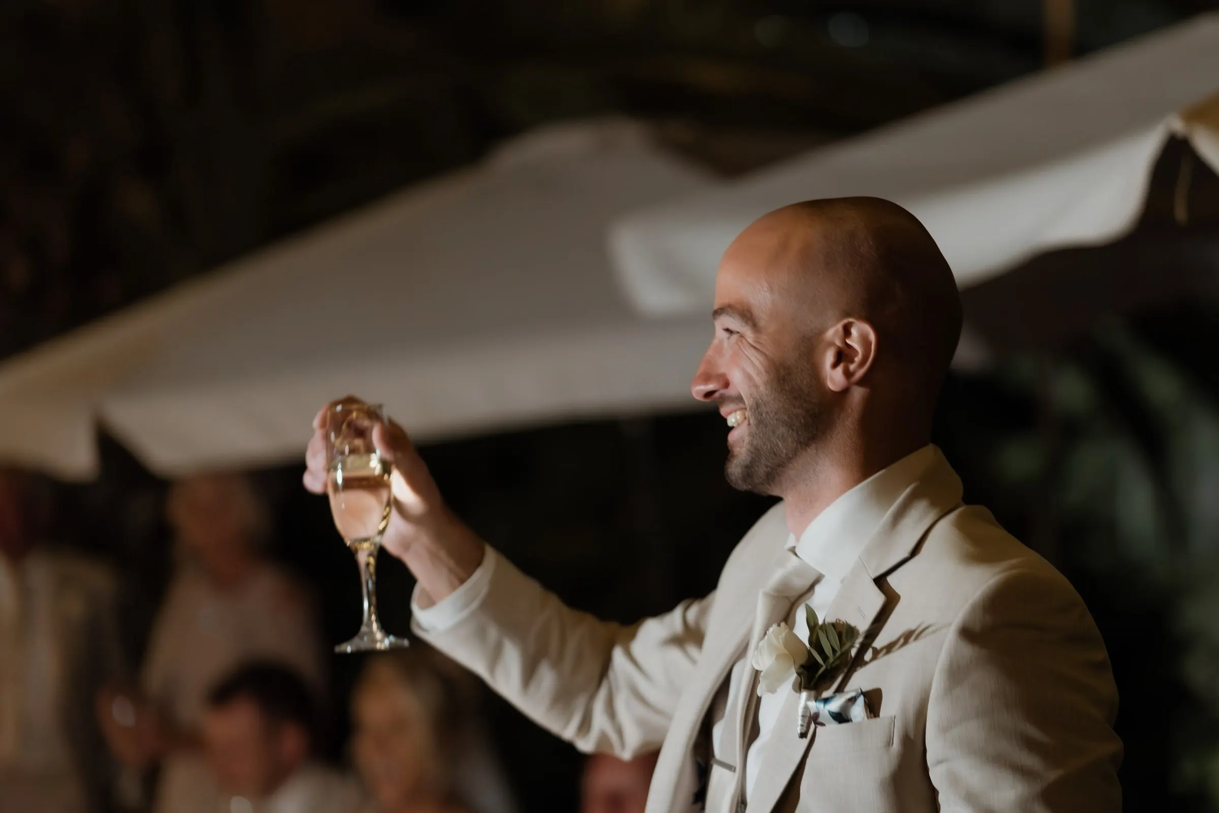 Best man raising a glass to the couple at the end of his speech