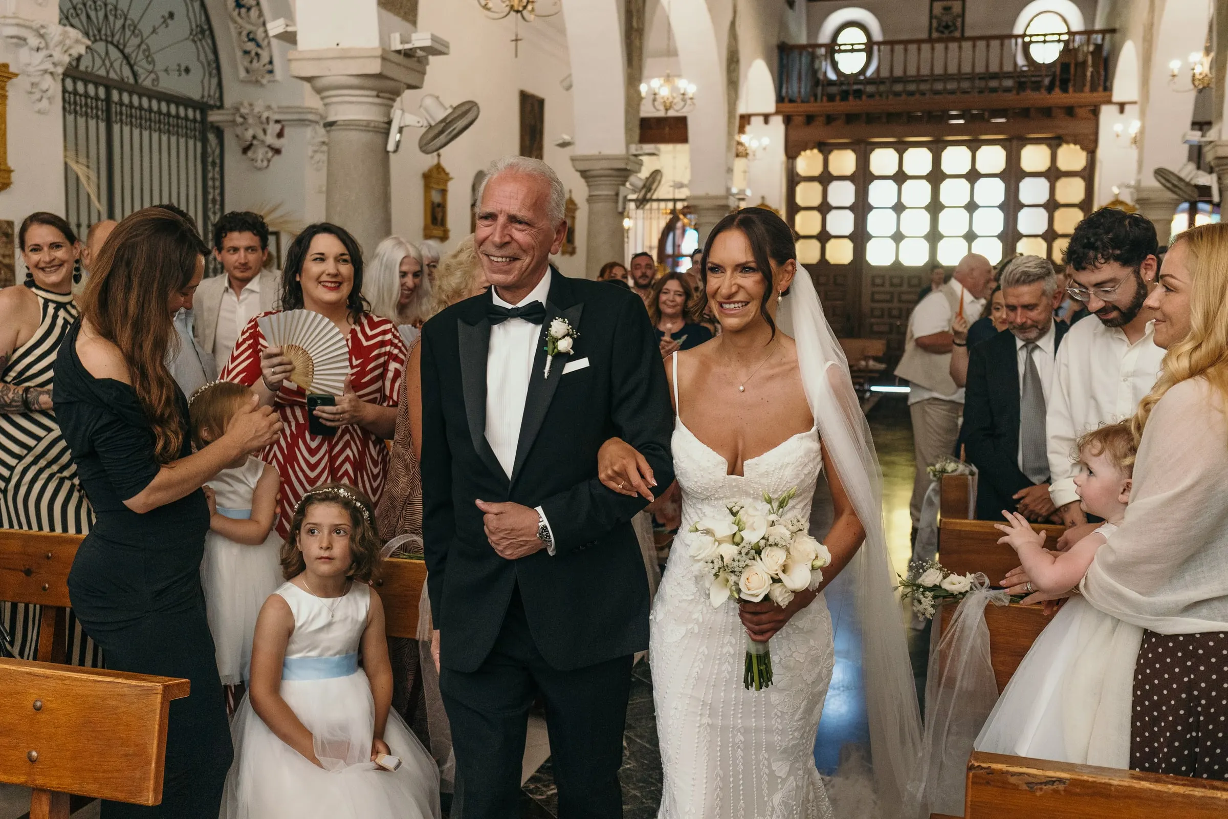 Bride walking down the aisle with her father, church wedding in Mijas Pueblo
