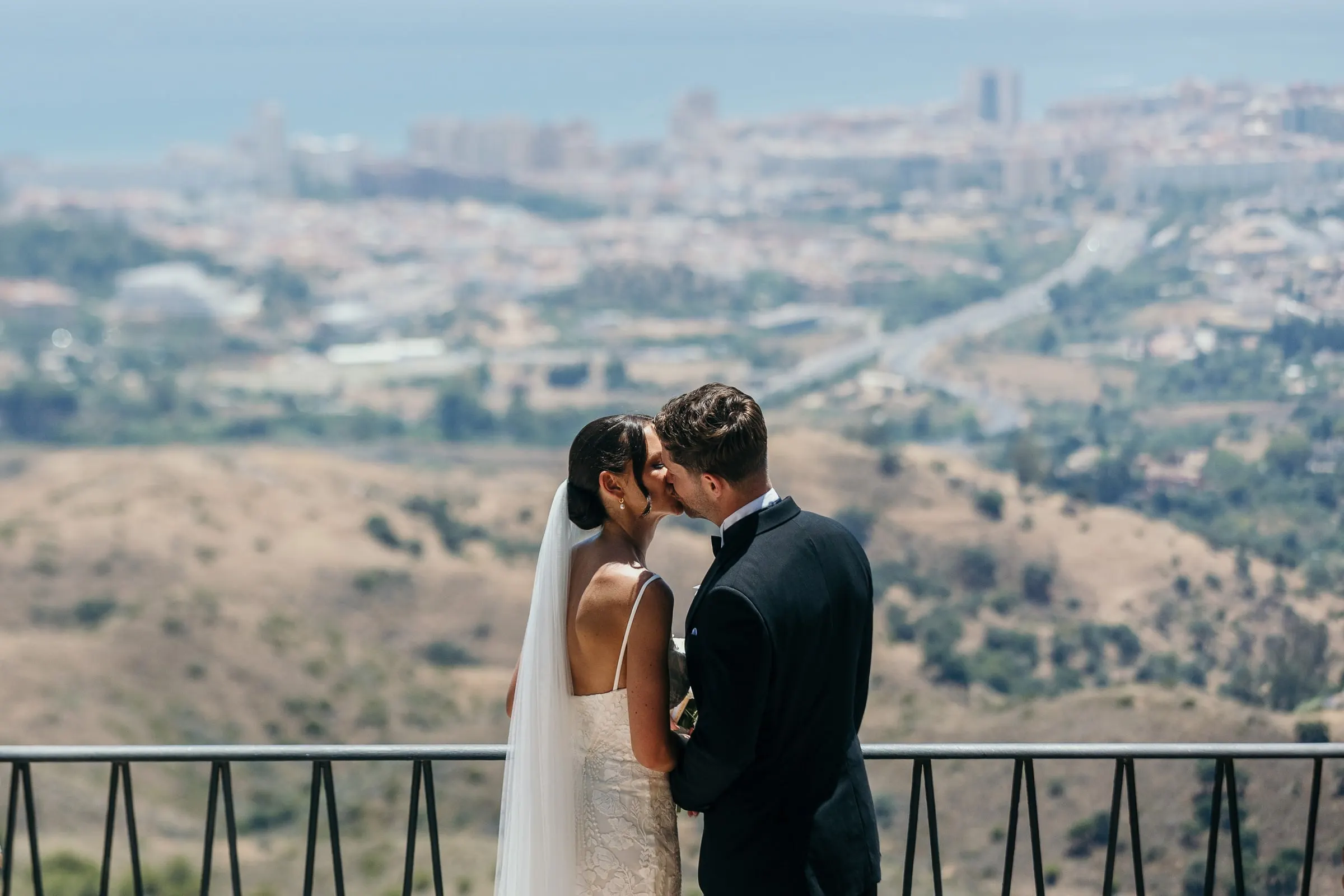 Couple kissing at a viewpoint above the Costa del Sol in Mijas Pueblo