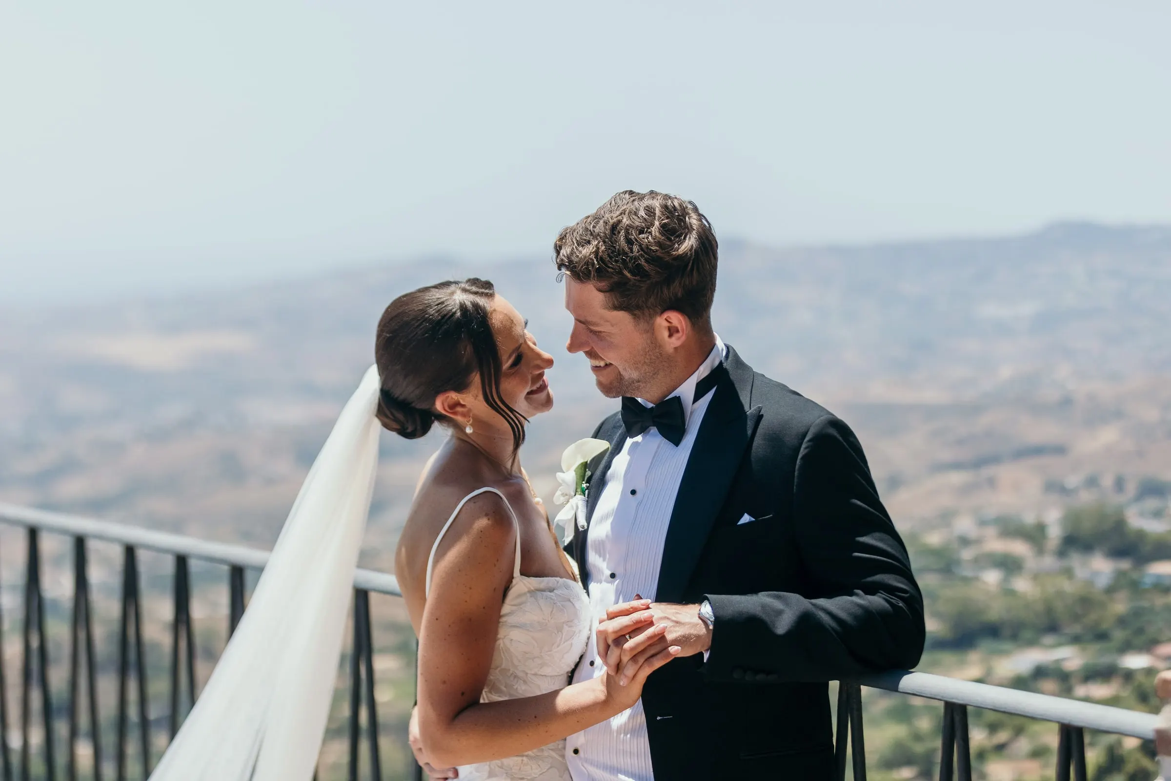 Couple close together at the viewpoint railing, Mijas wedding