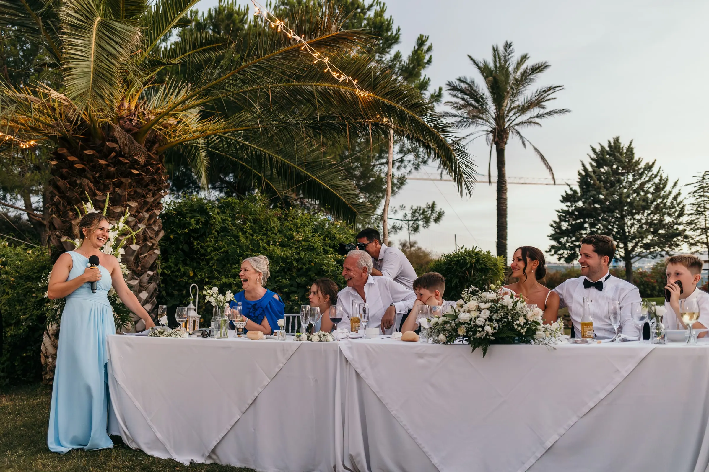 Wedding dinner tables under the palm trees at dusk, Hacienda San José
