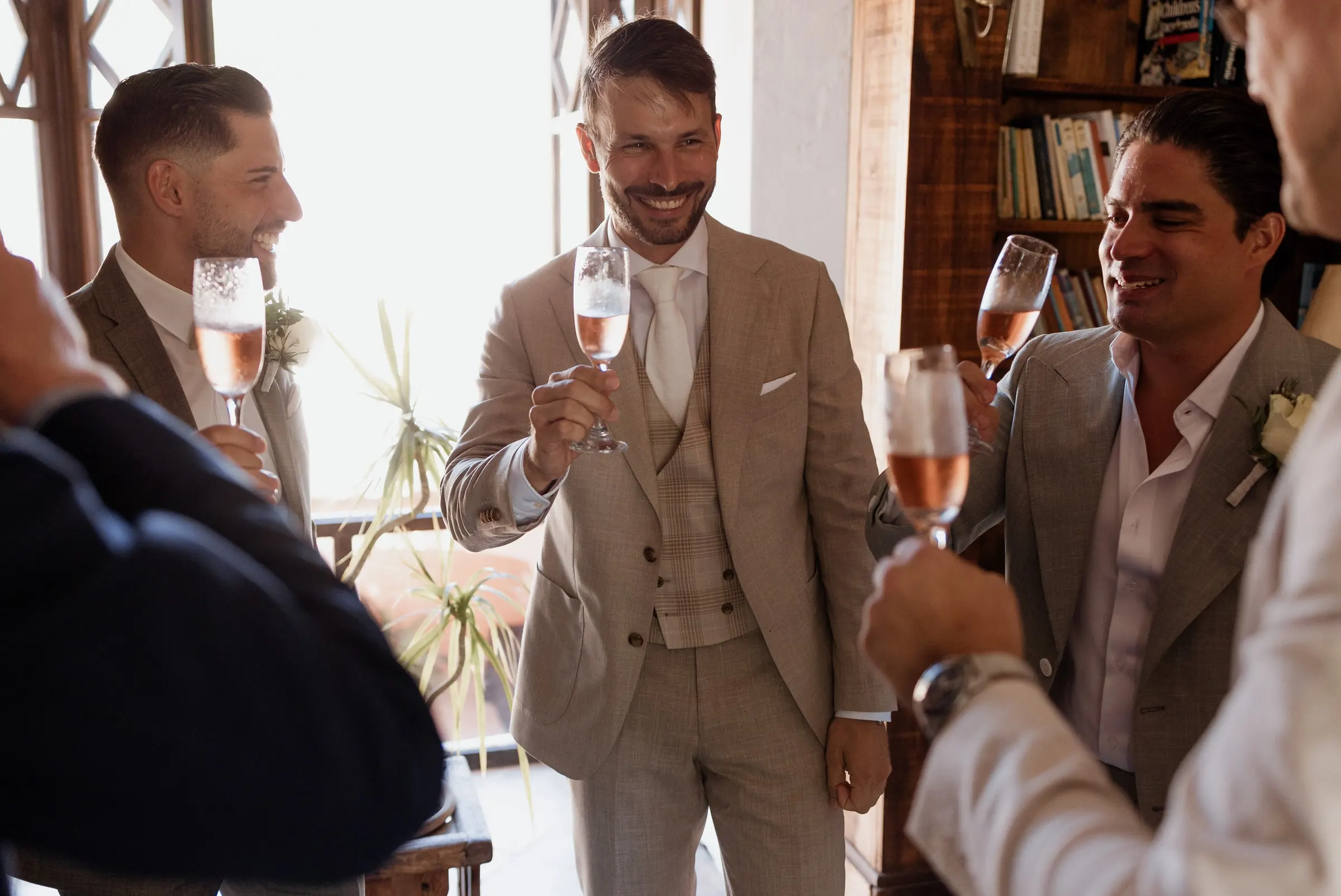 The groom raising a glass of rosé with his friends before the ceremony, Hacienda San José, Mijas
