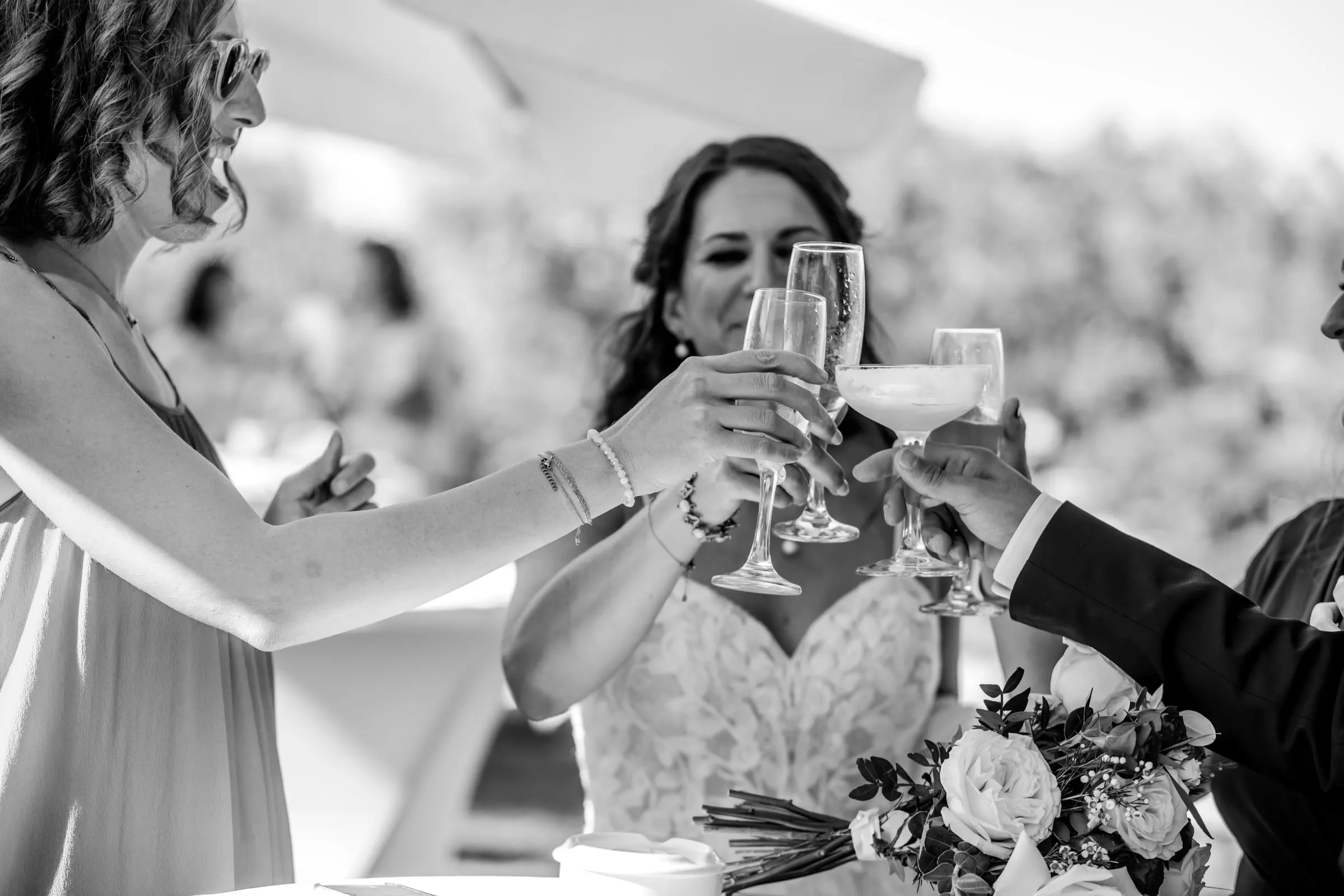 Black and white of the bride clinking glasses with guests at the table, Hacienda San José, Mijas