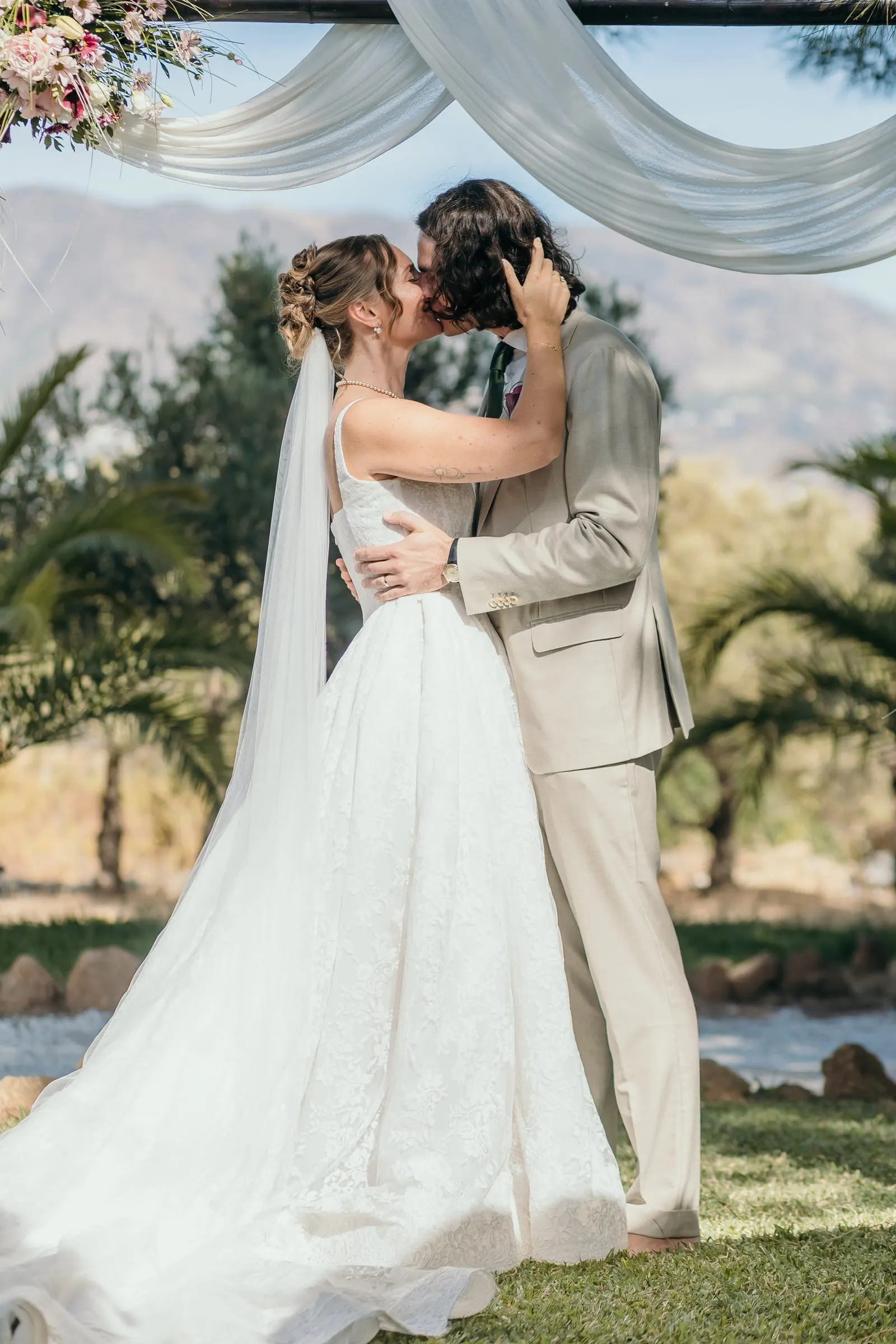 The couple kissing under the draped canopy with the mountains behind, Hacienda San José, Mijas