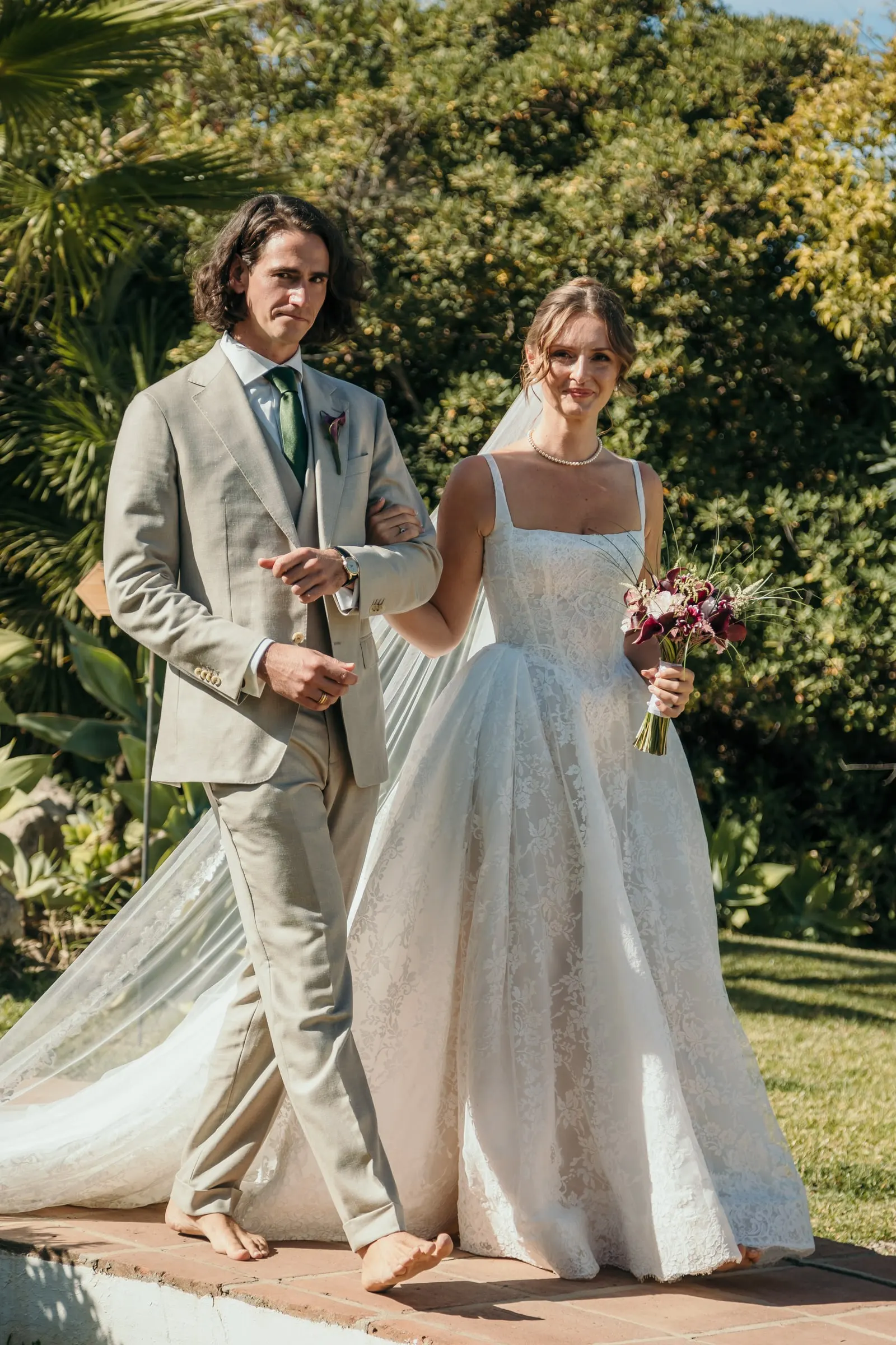 Bride and groom walking barefoot side by side after the ceremony, Hacienda San José, Mijas
