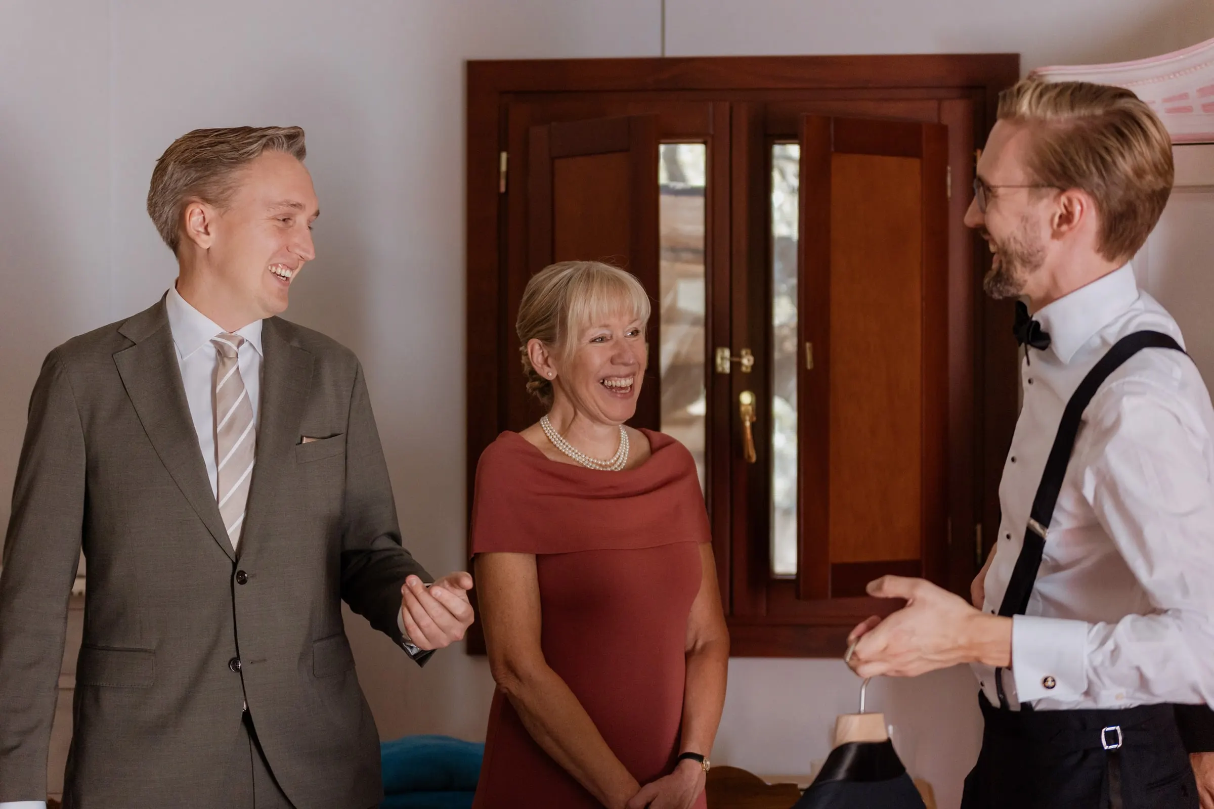 Groom laughing with his mother and a friend while getting ready at Los Pilares de Ronda
