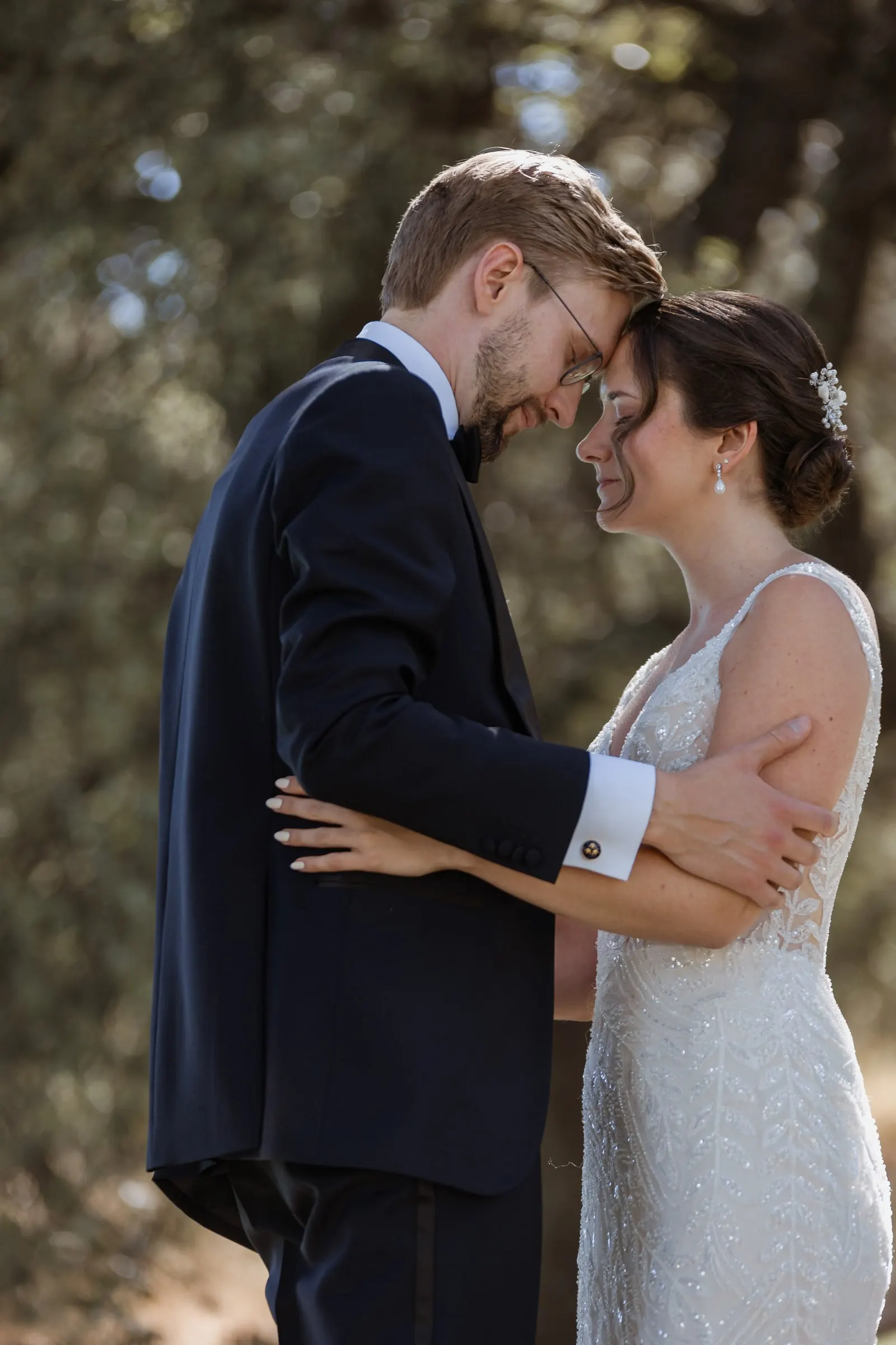 Close embrace, foreheads touching, in the shade of the Ronda garden