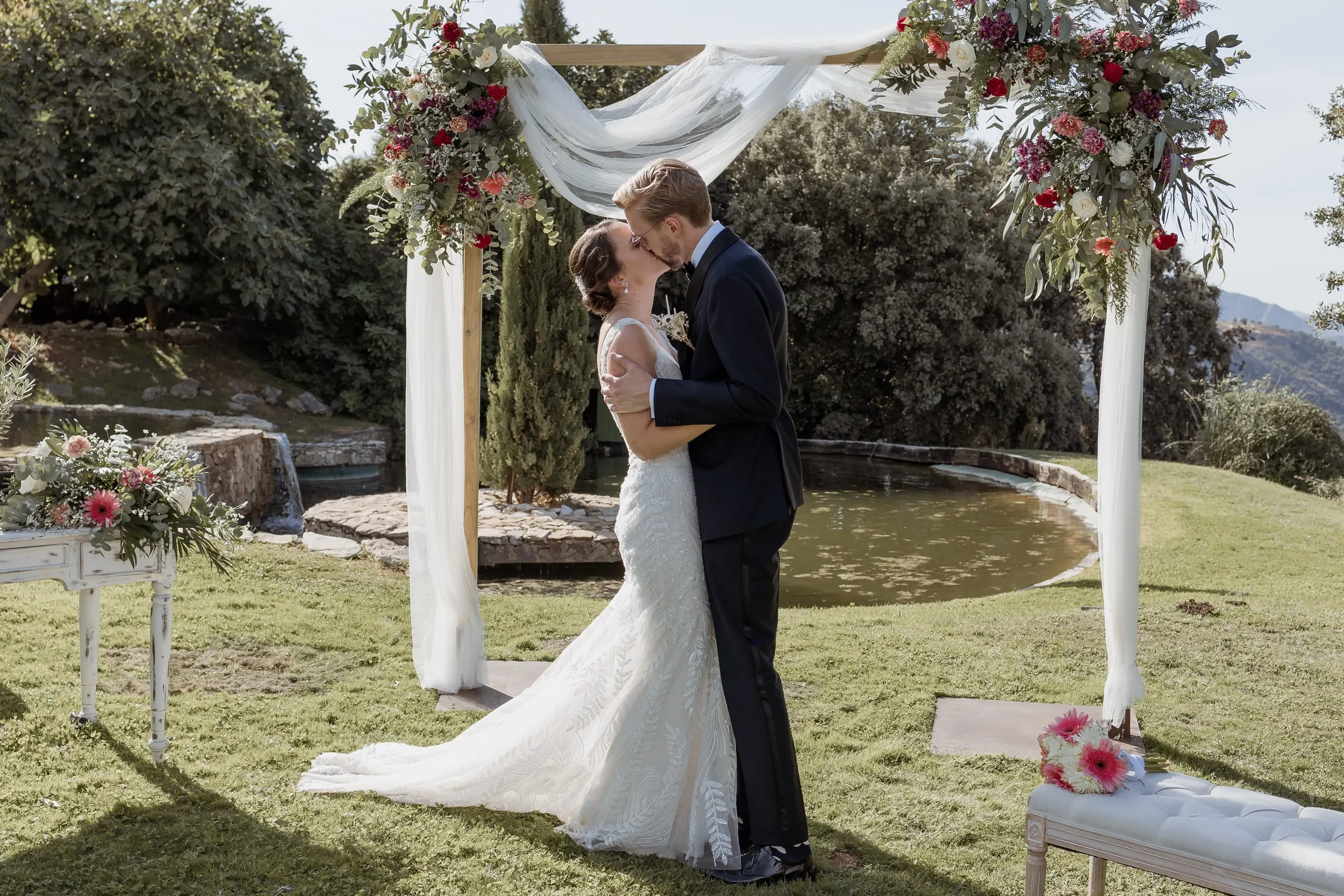 First kiss as a married couple under the arch at Los Pilares de Ronda