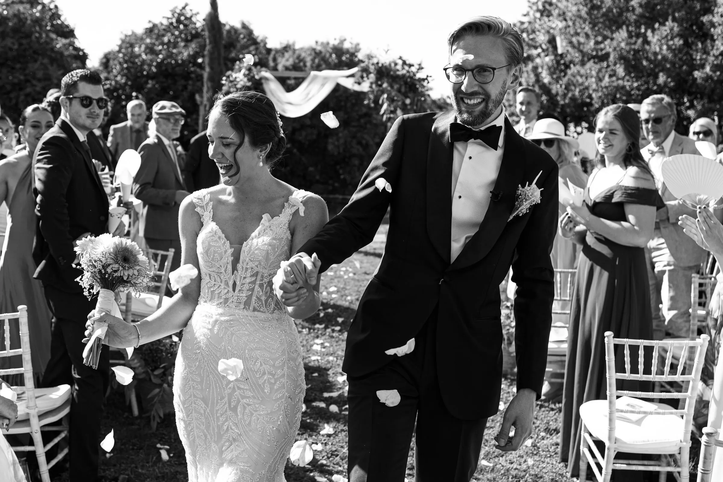 Black and white recessional under a shower of petals in Ronda