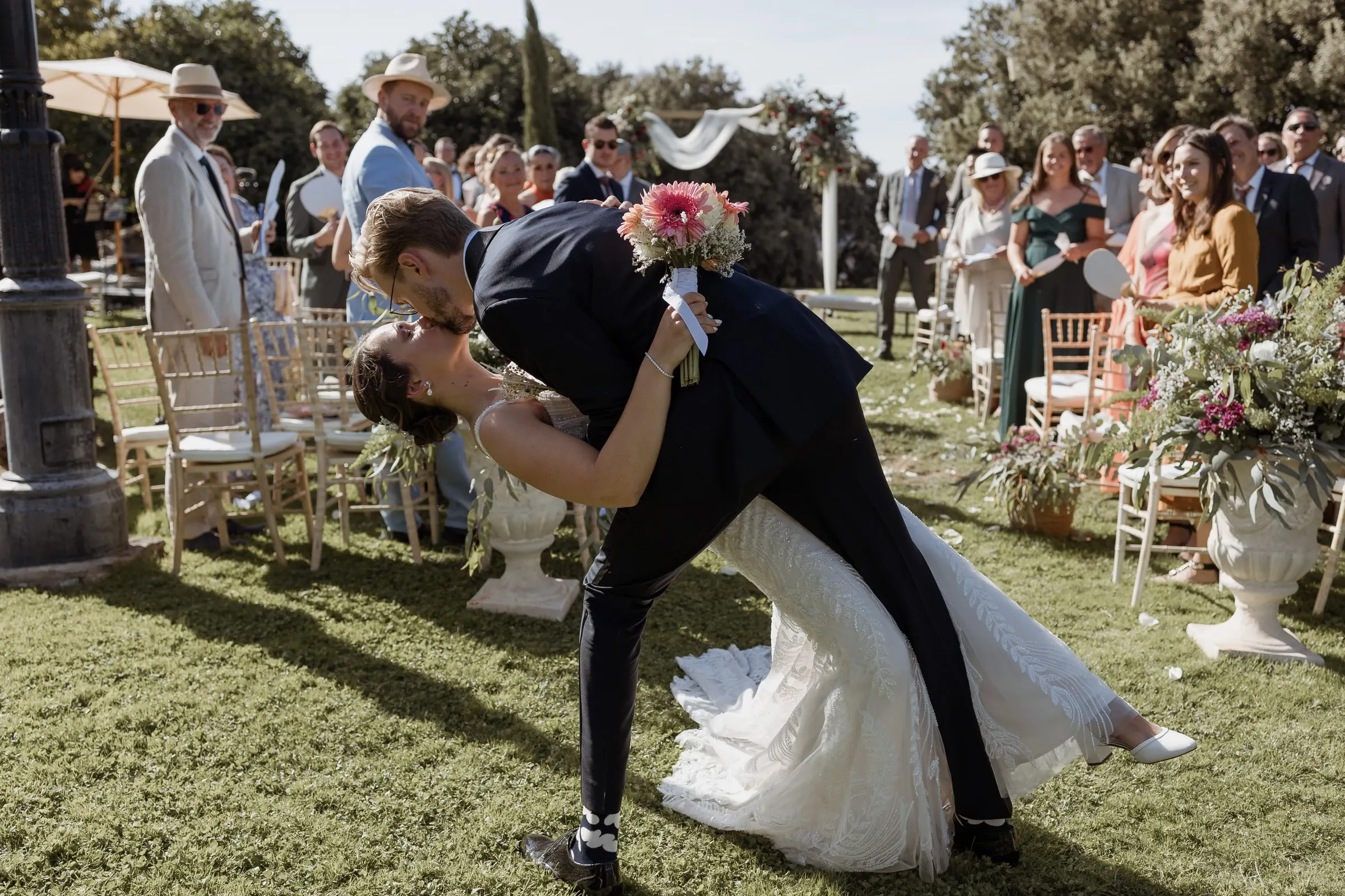 Groom dipping the bride for a kiss in the middle of the aisle at Los Pilares de Ronda