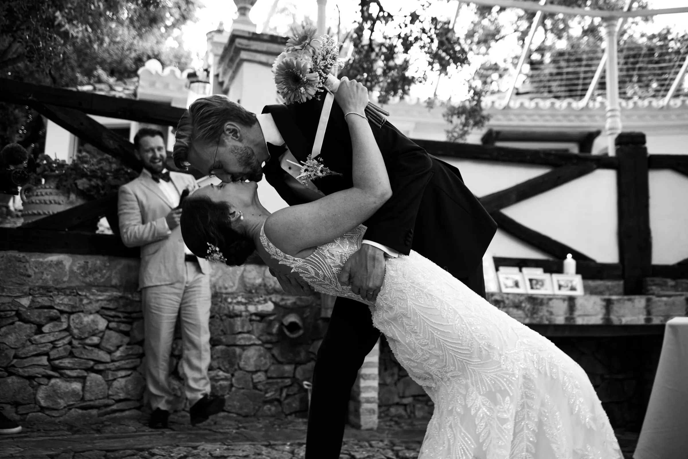 Black and white dip kiss by the wooden railing of the Ronda finca