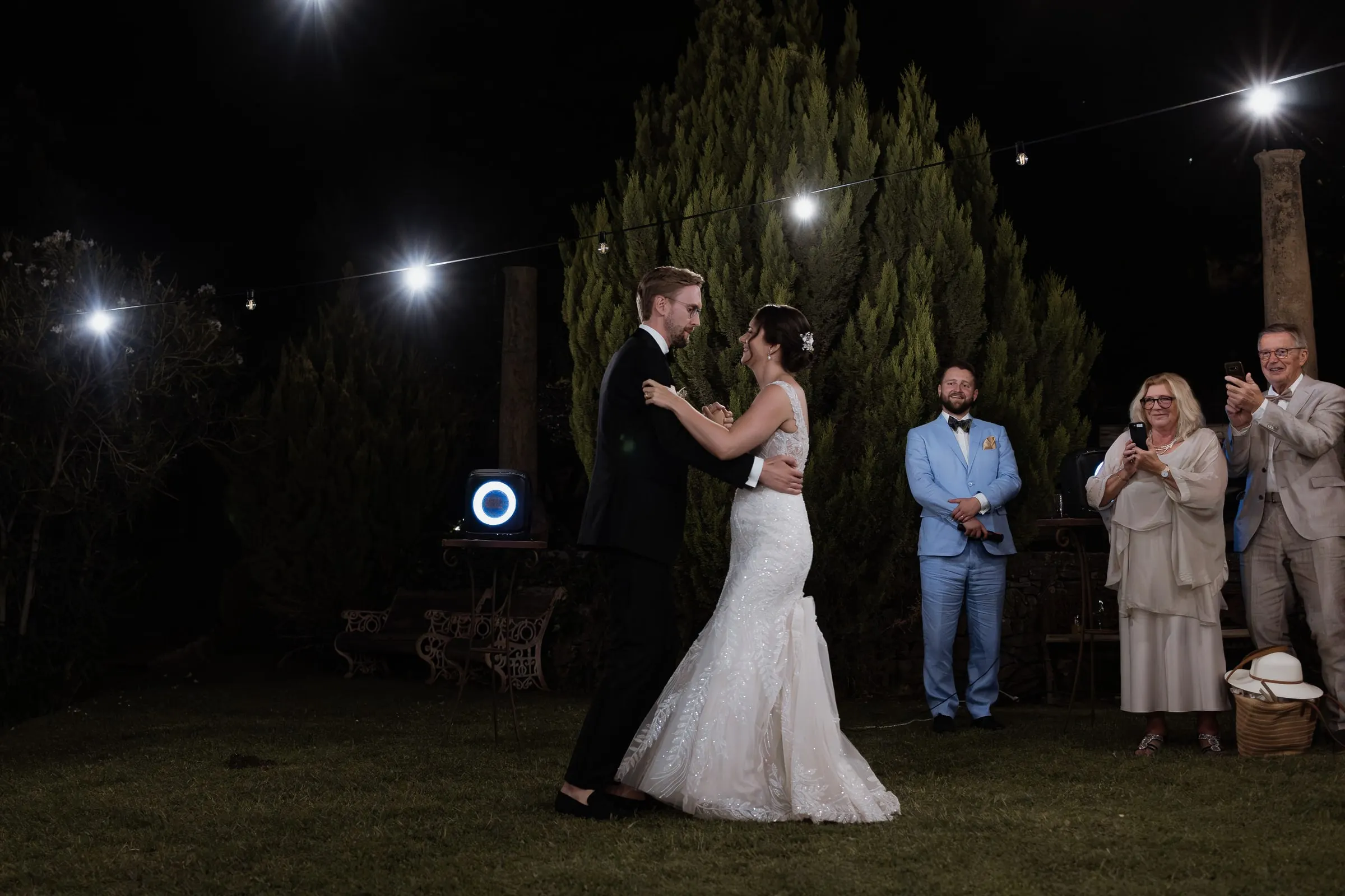 First dance on the lawn under string lights at Los Pilares de Ronda