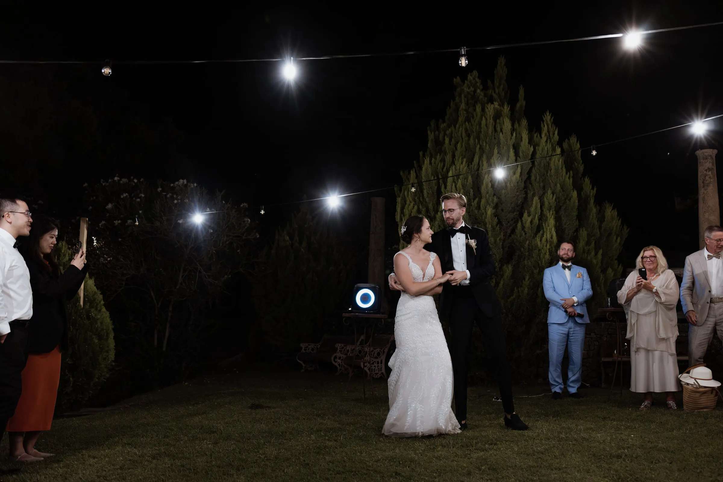 Wide view of the first dance as guests film on their phones