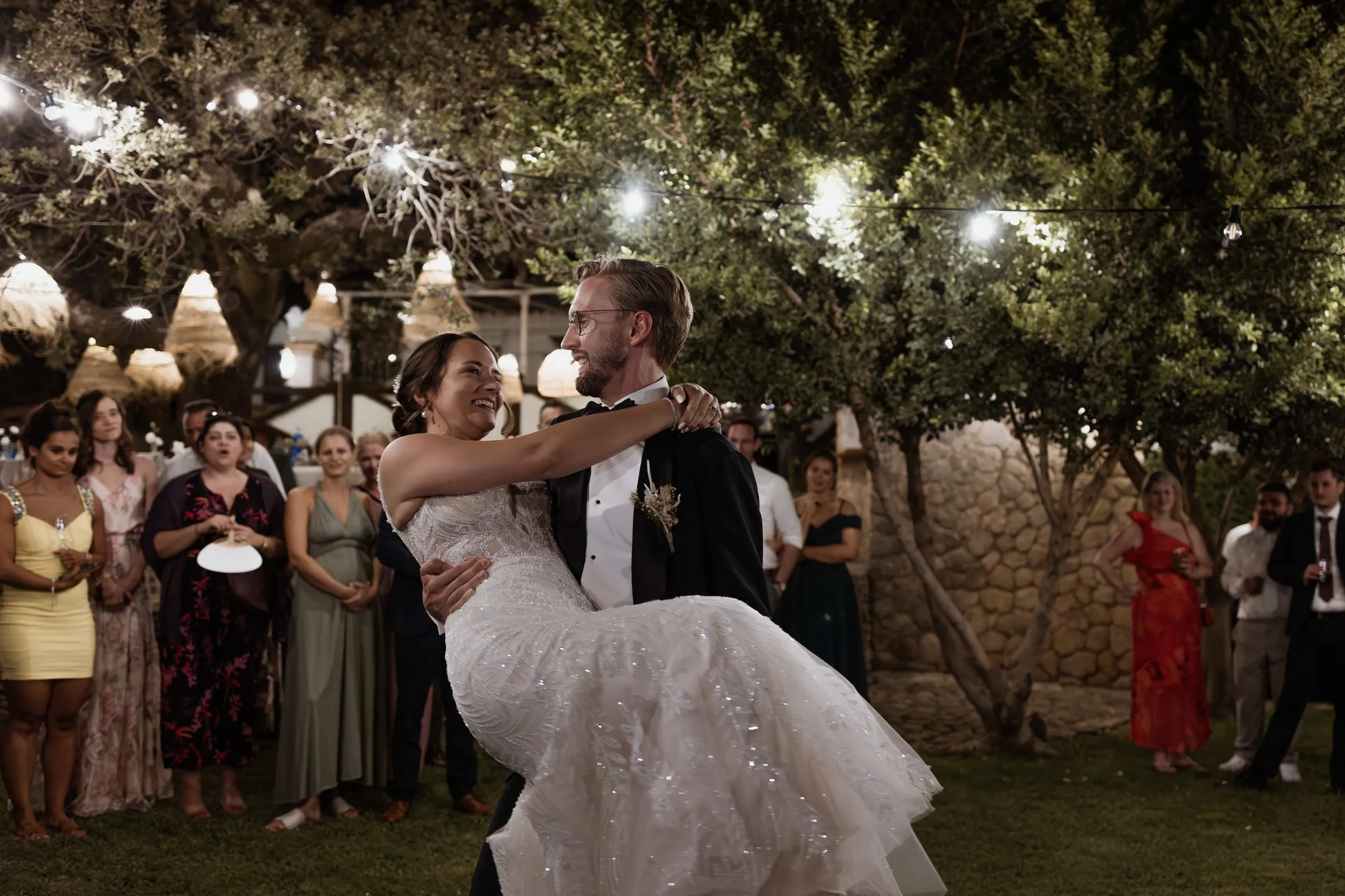 Groom lifting the bride off her feet on the dance floor