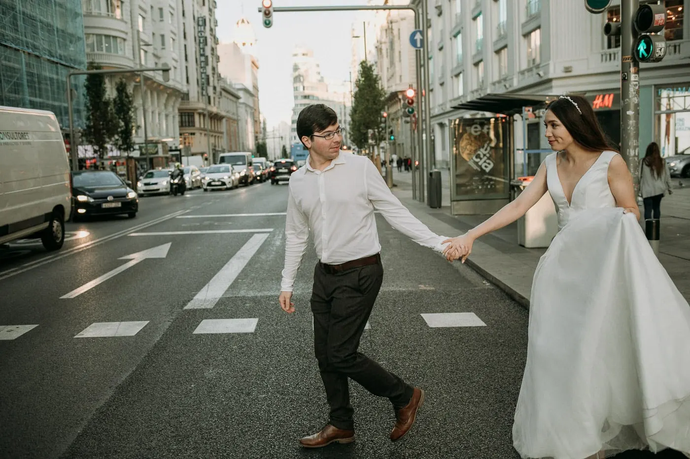 Bride and groom crossing Gran Vía hand in hand
