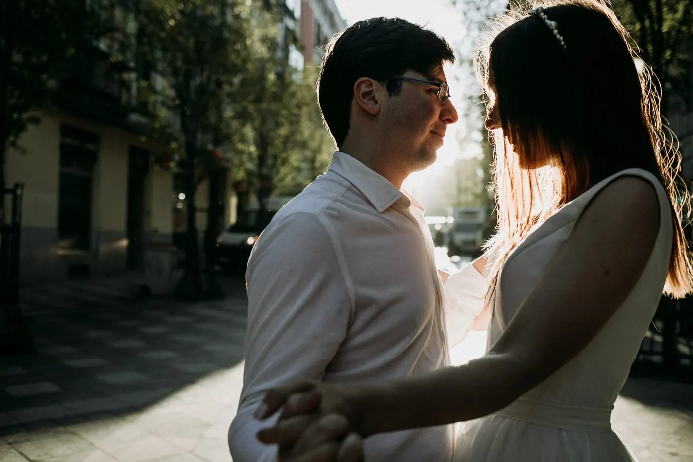 Backlit bride and groom face to face, the sun in her hair