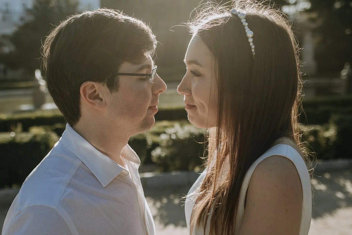 Bride and groom face to face, eyes nearly closed