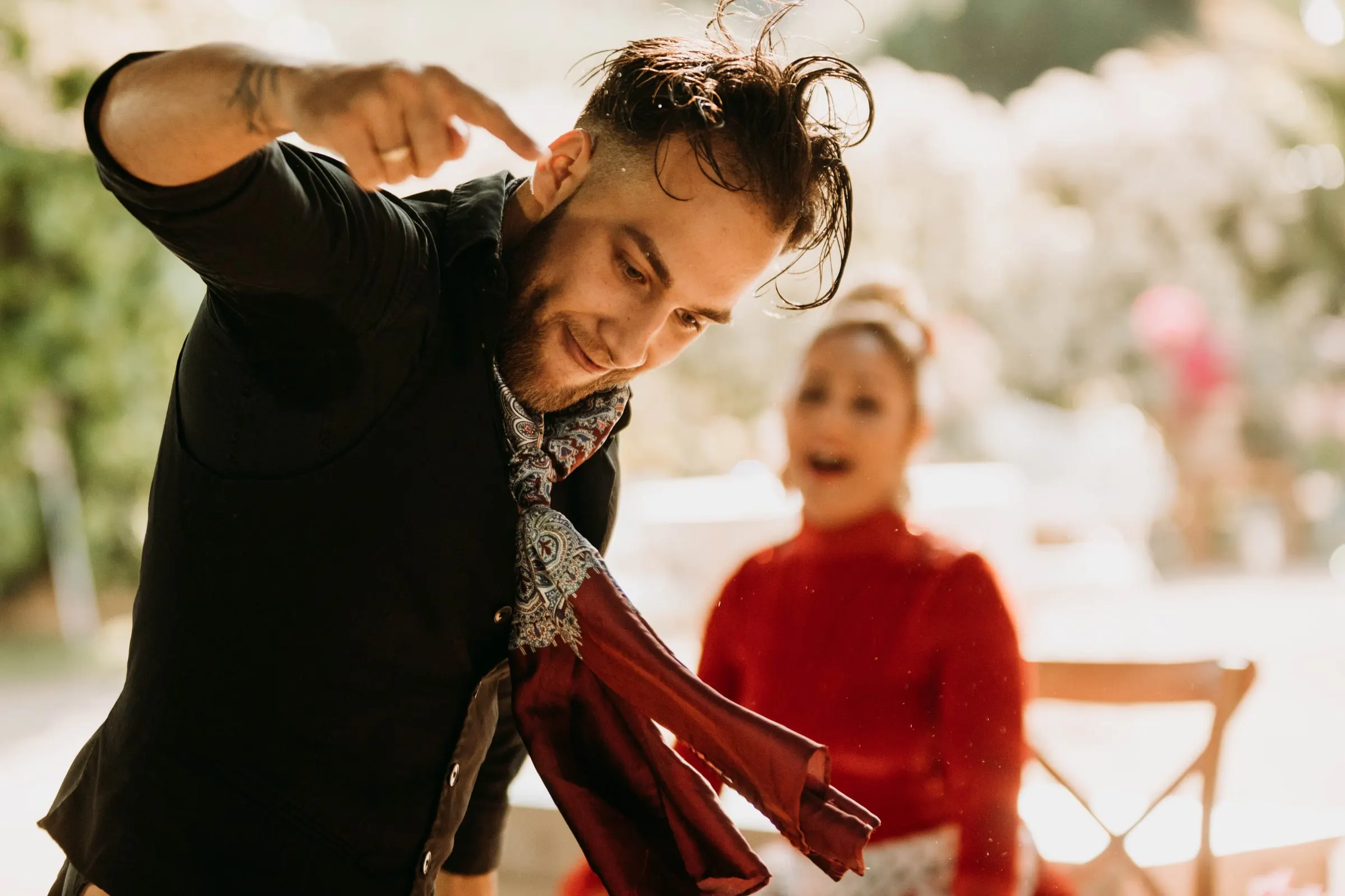 A flamenco singer pointing playfully as a guest in red laughs behind him, at a masia in Girona