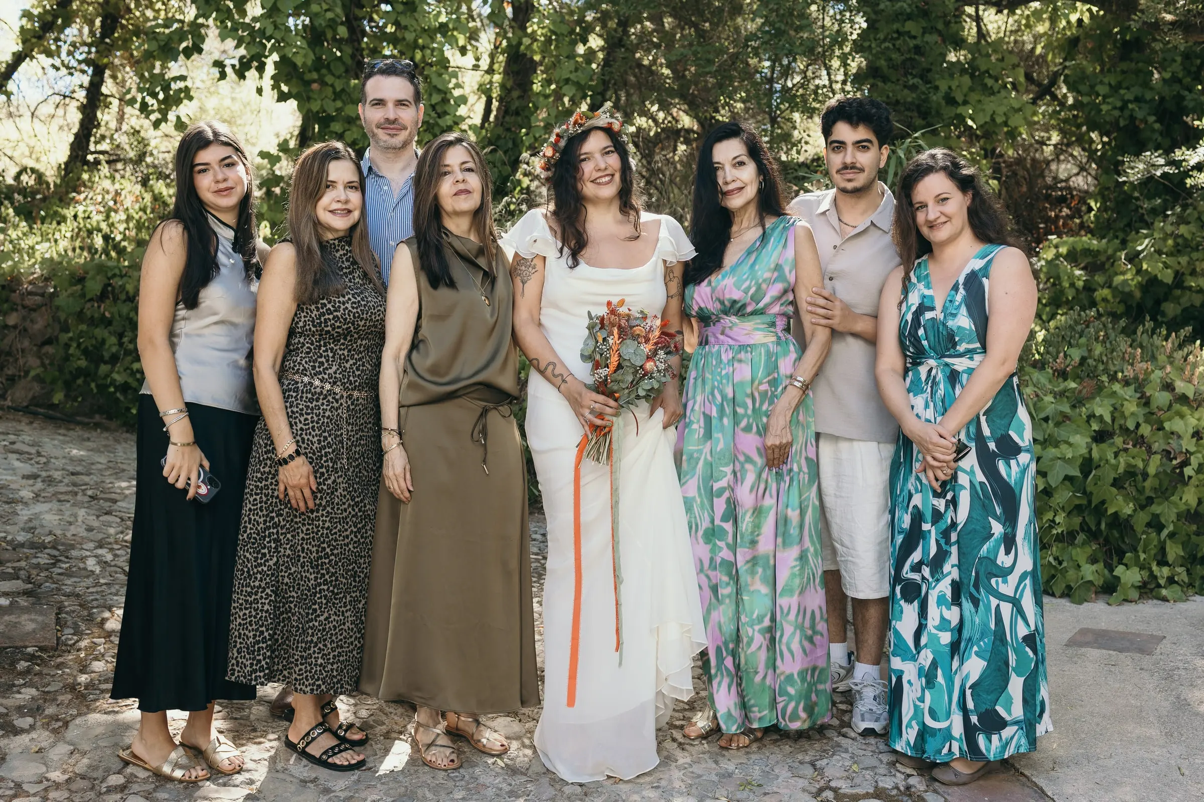 Bride with her family and friends in summer dresses in the garden