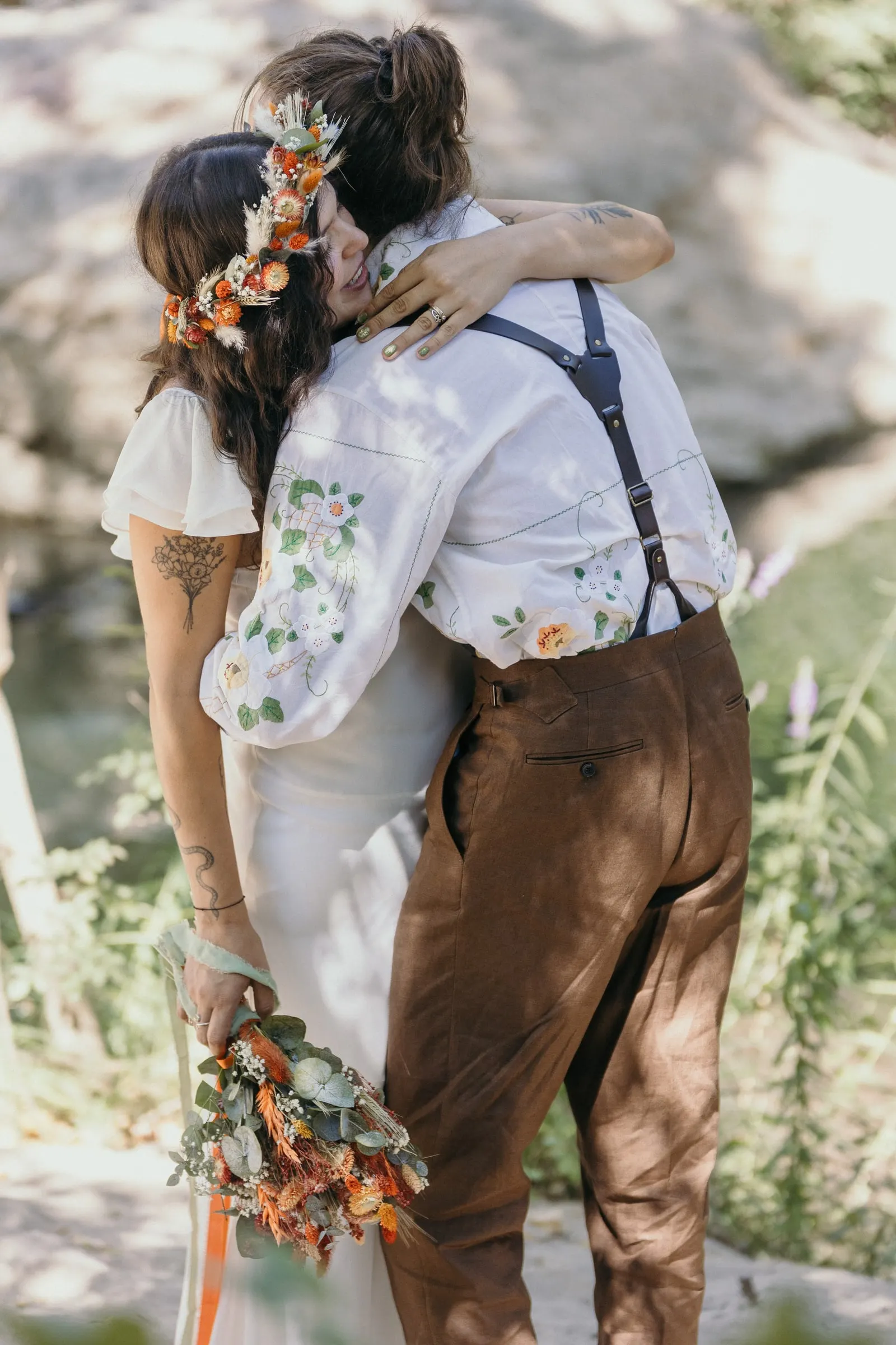 Bride and groom embracing after their first look by the water