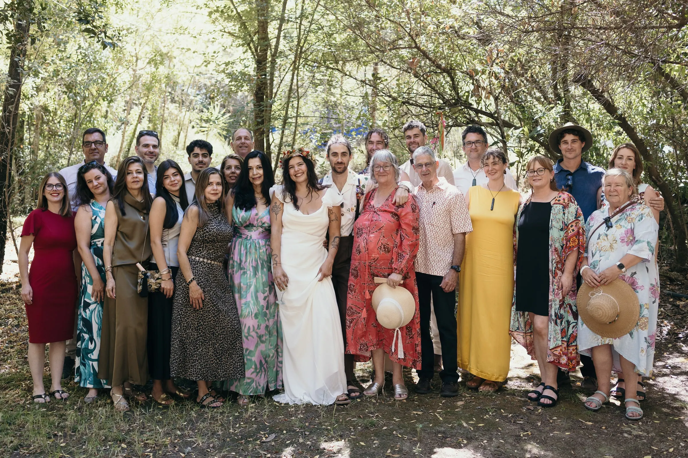 Group photo of all the guests among the trees at Molino La Flor