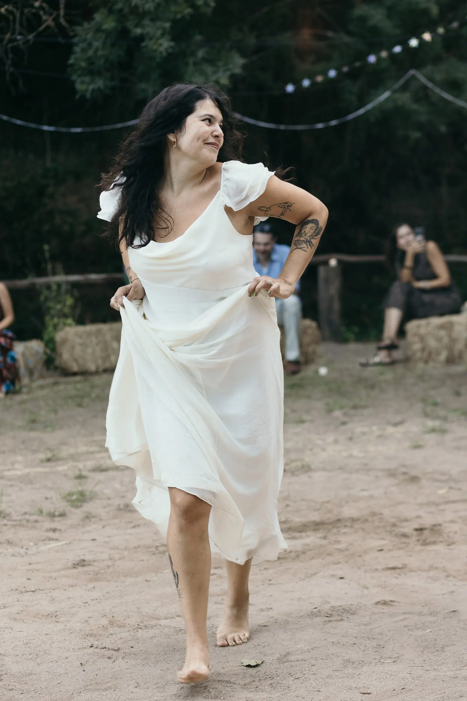 Bride dancing barefoot on the sandy dance floor at Molino La Flor